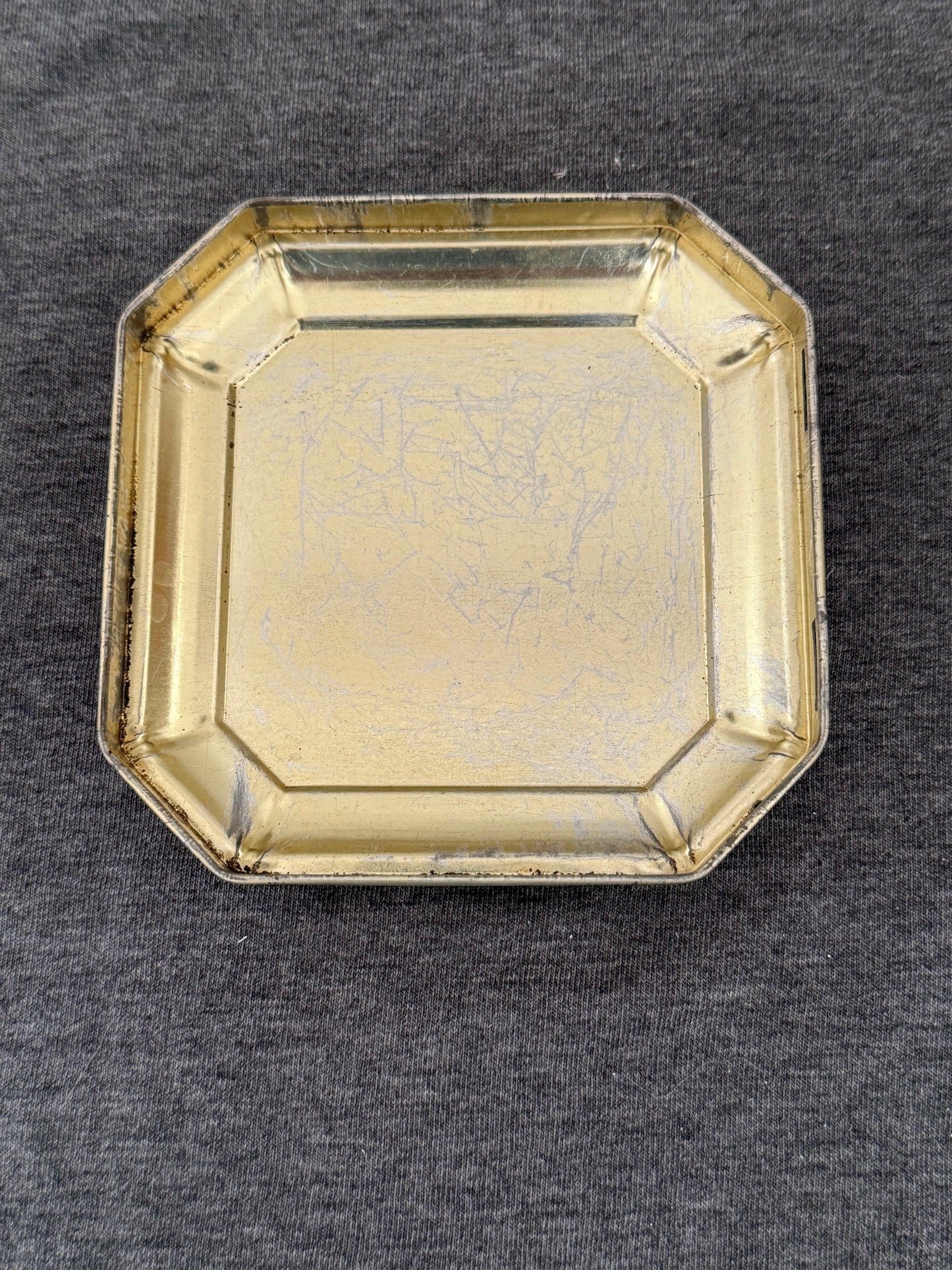Gold metallic tray on a gray background