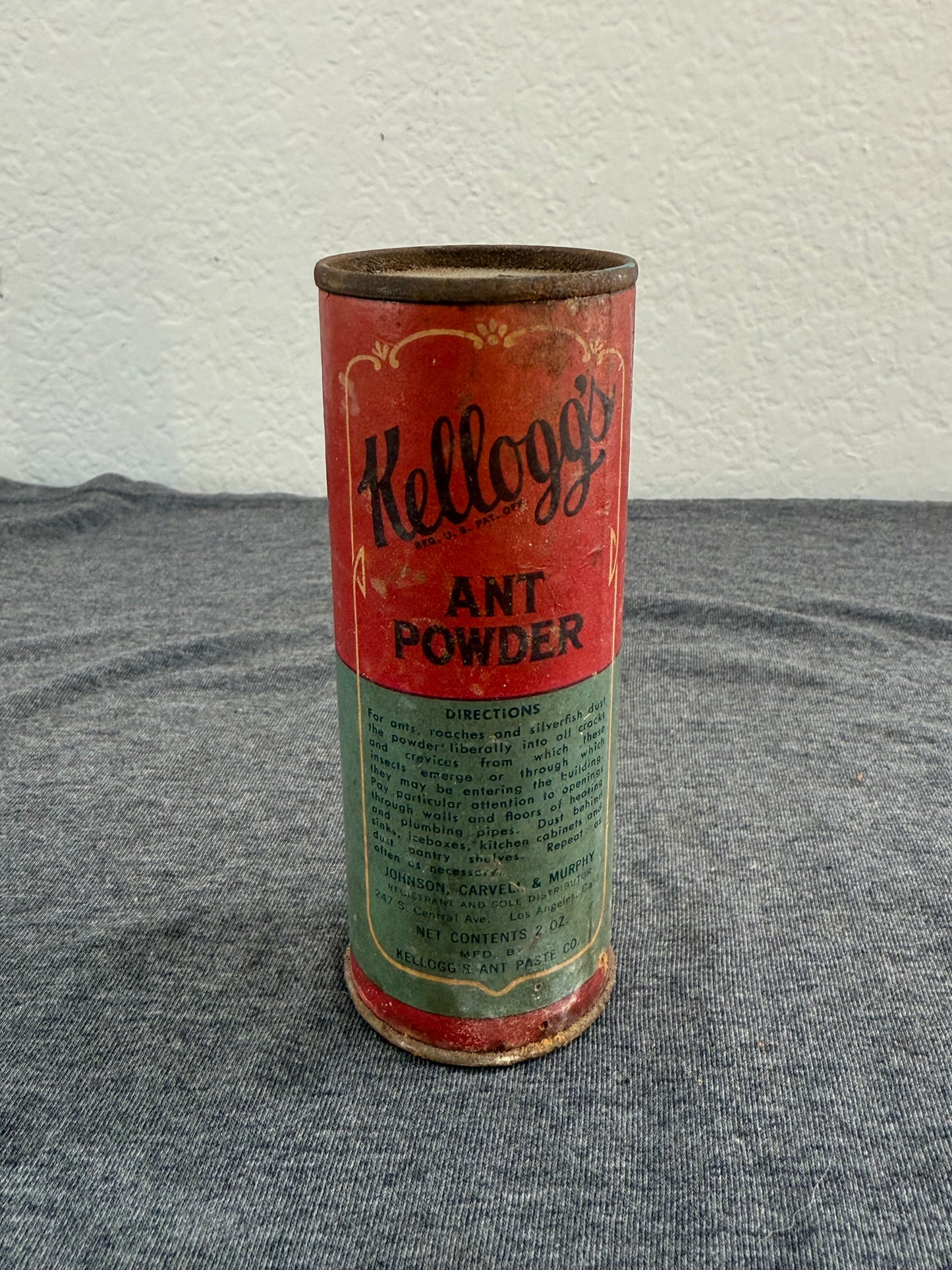 Vintage Kellogg's Ant Powder can on a textured surface