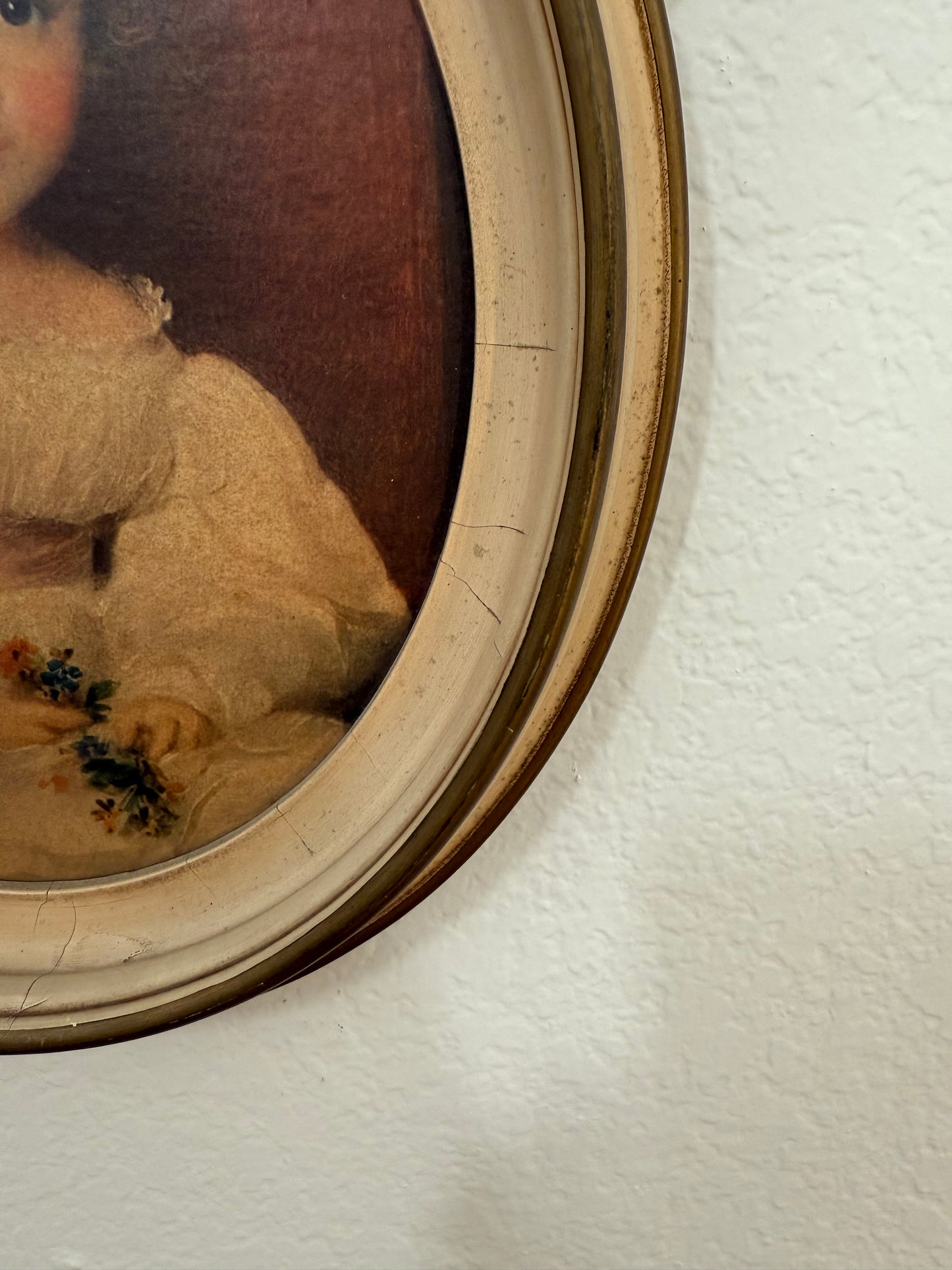 Close-up of a framed portrait with a textured wall background