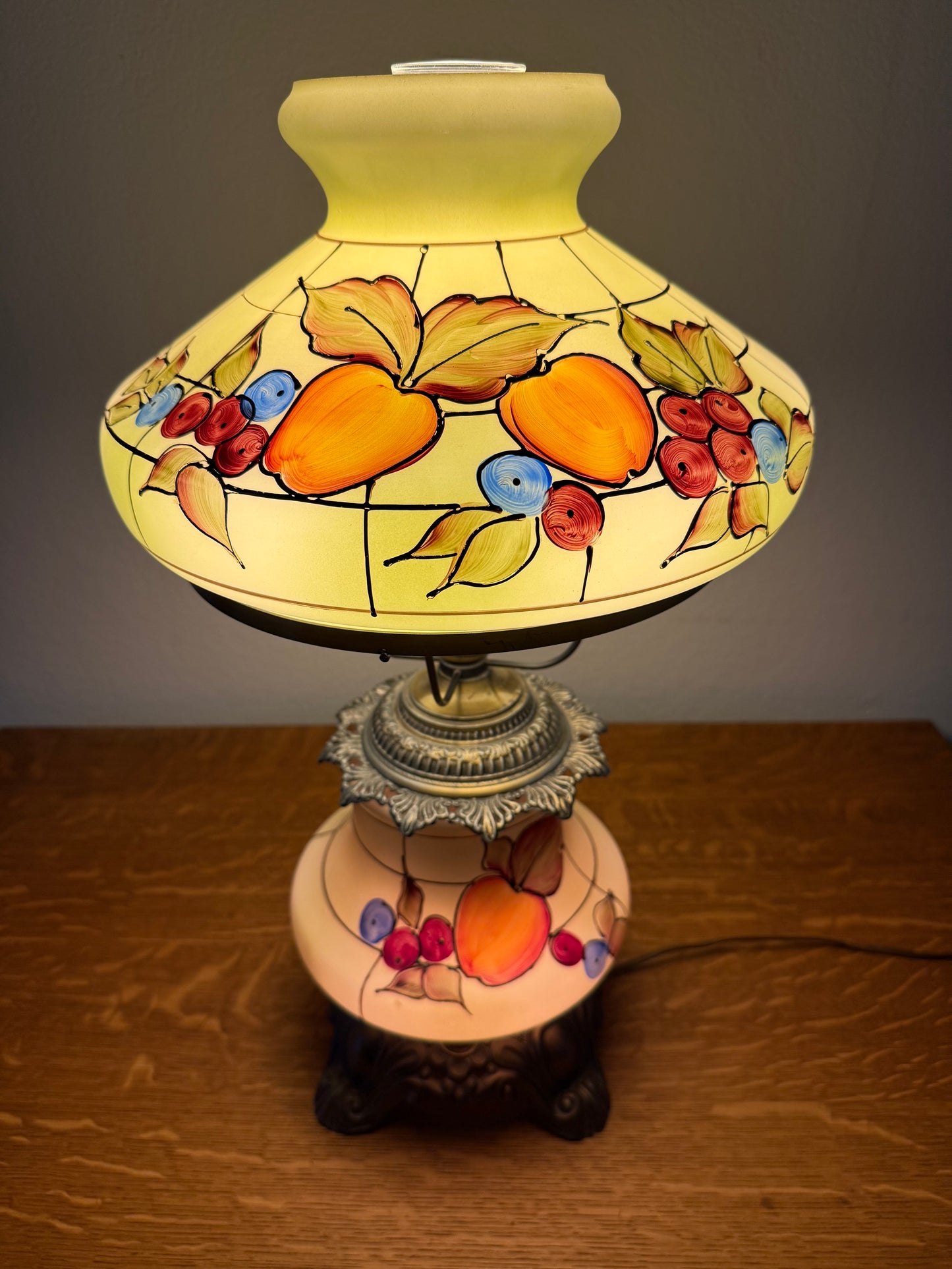 Decorative lamp with fruit design on a plain background