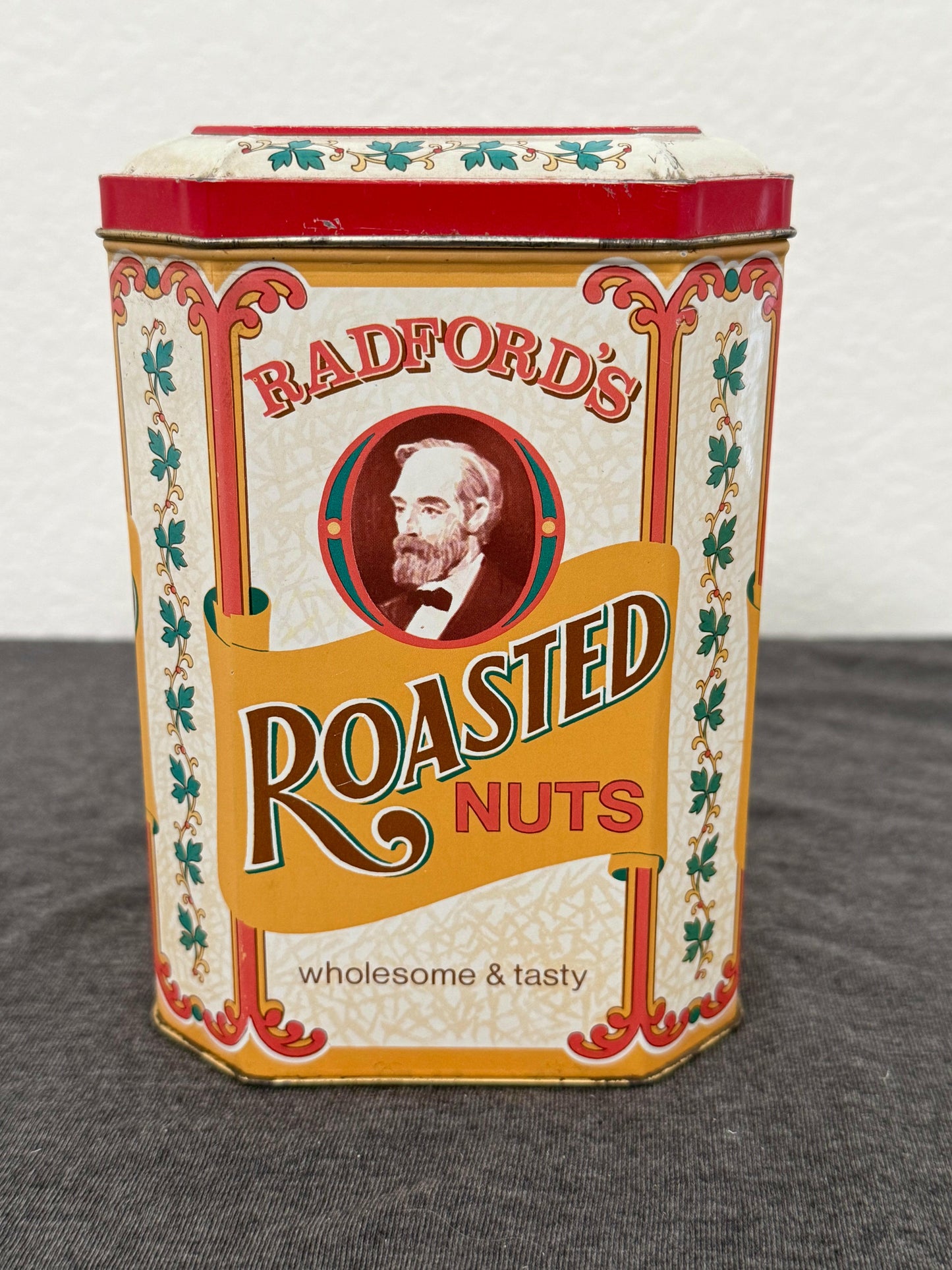 Vintage-style packaging for 'Radford's Roasted Nuts' on a white and gray background