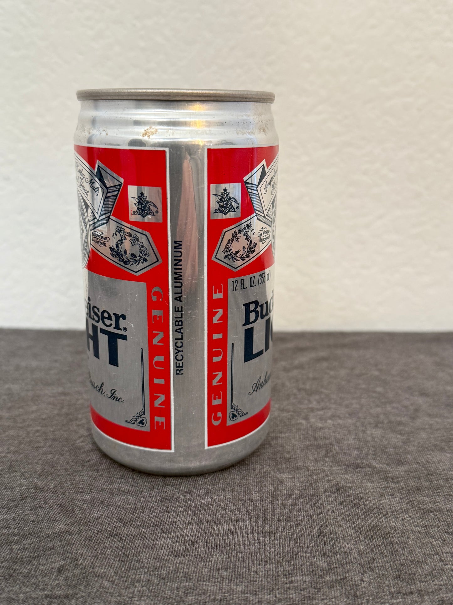 Budweiser can on a textured surface