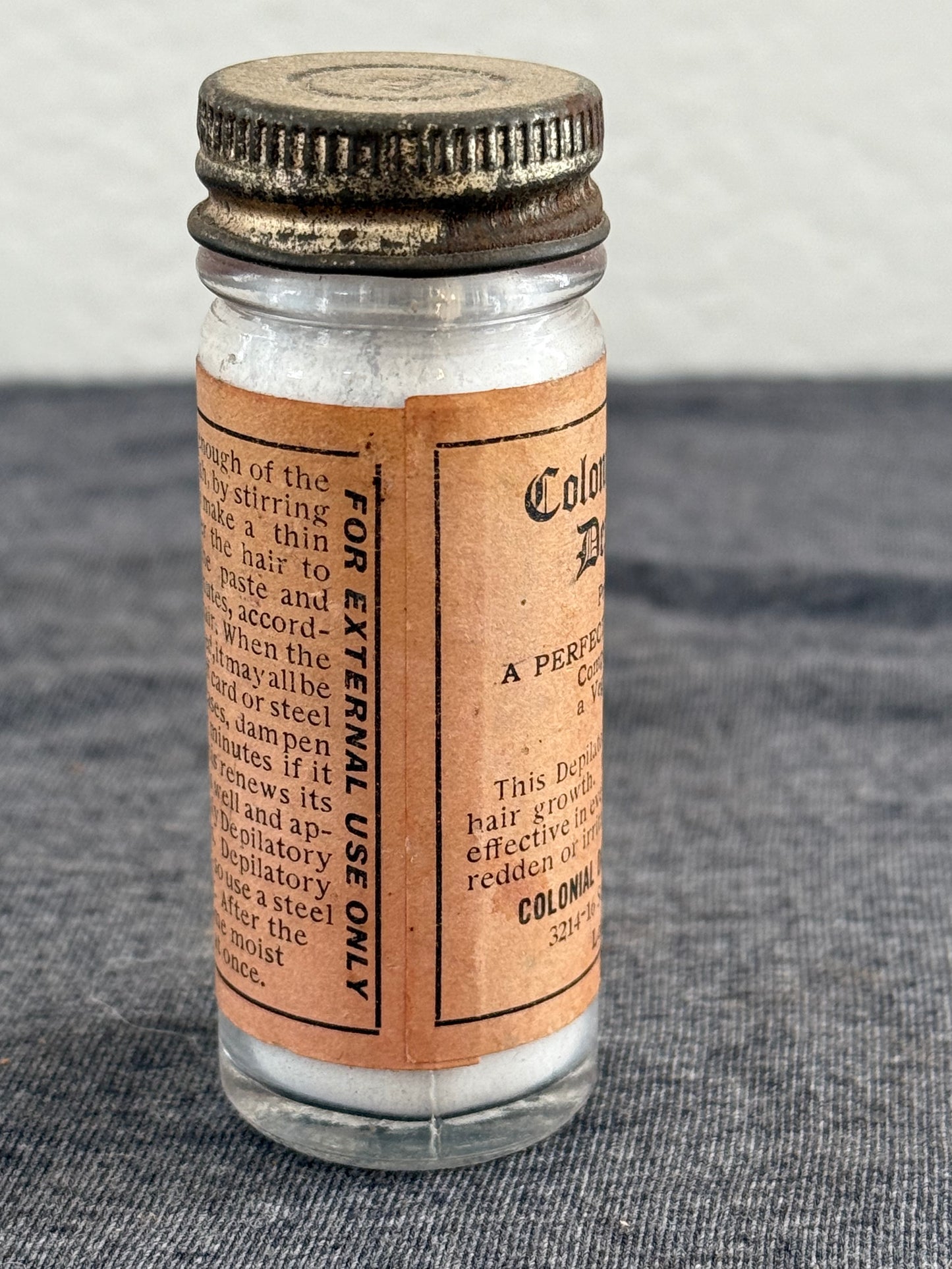 Vintage-style medicine bottle with label on a textured surface