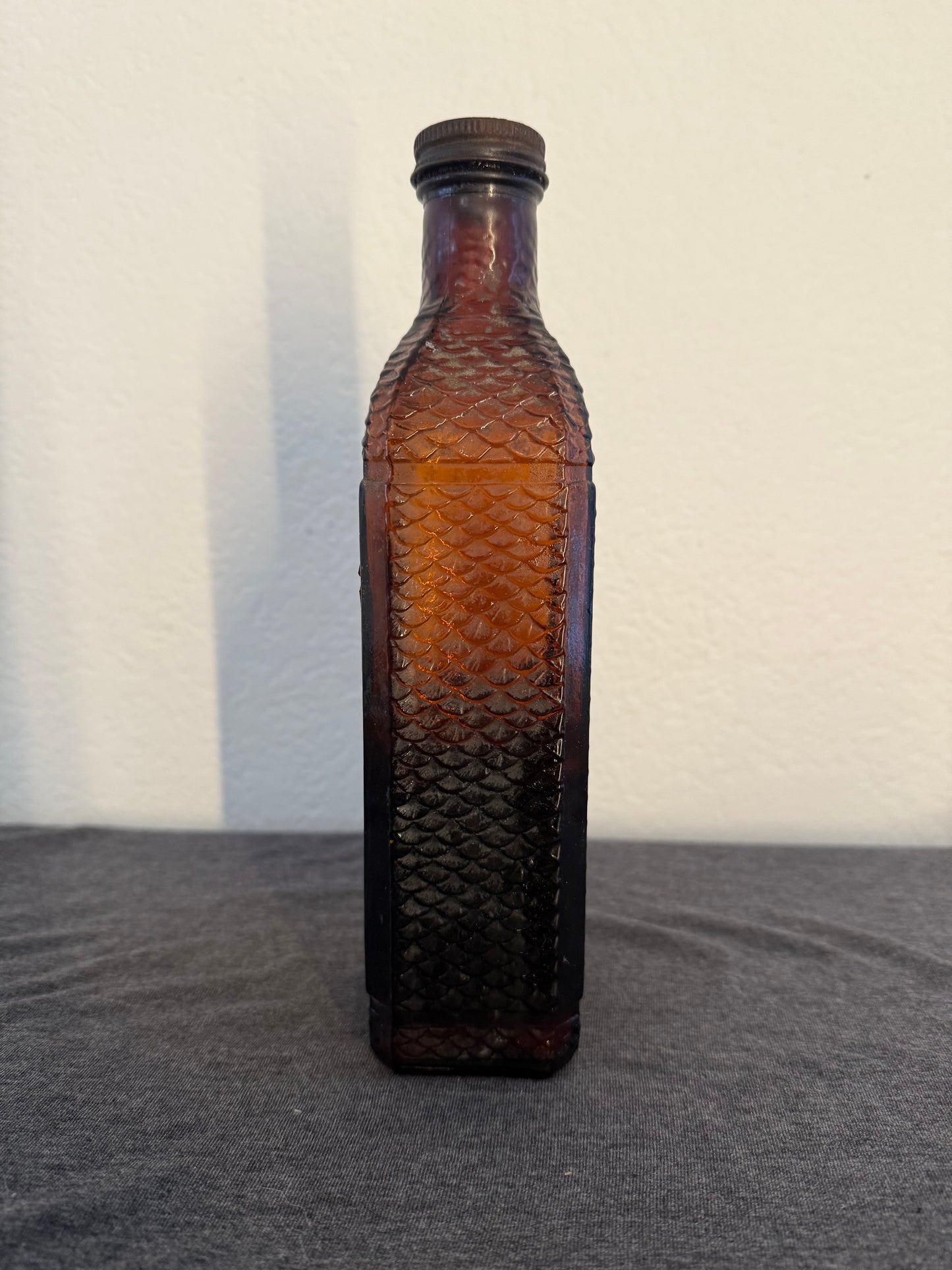 Brown glass bottle on a light gray background