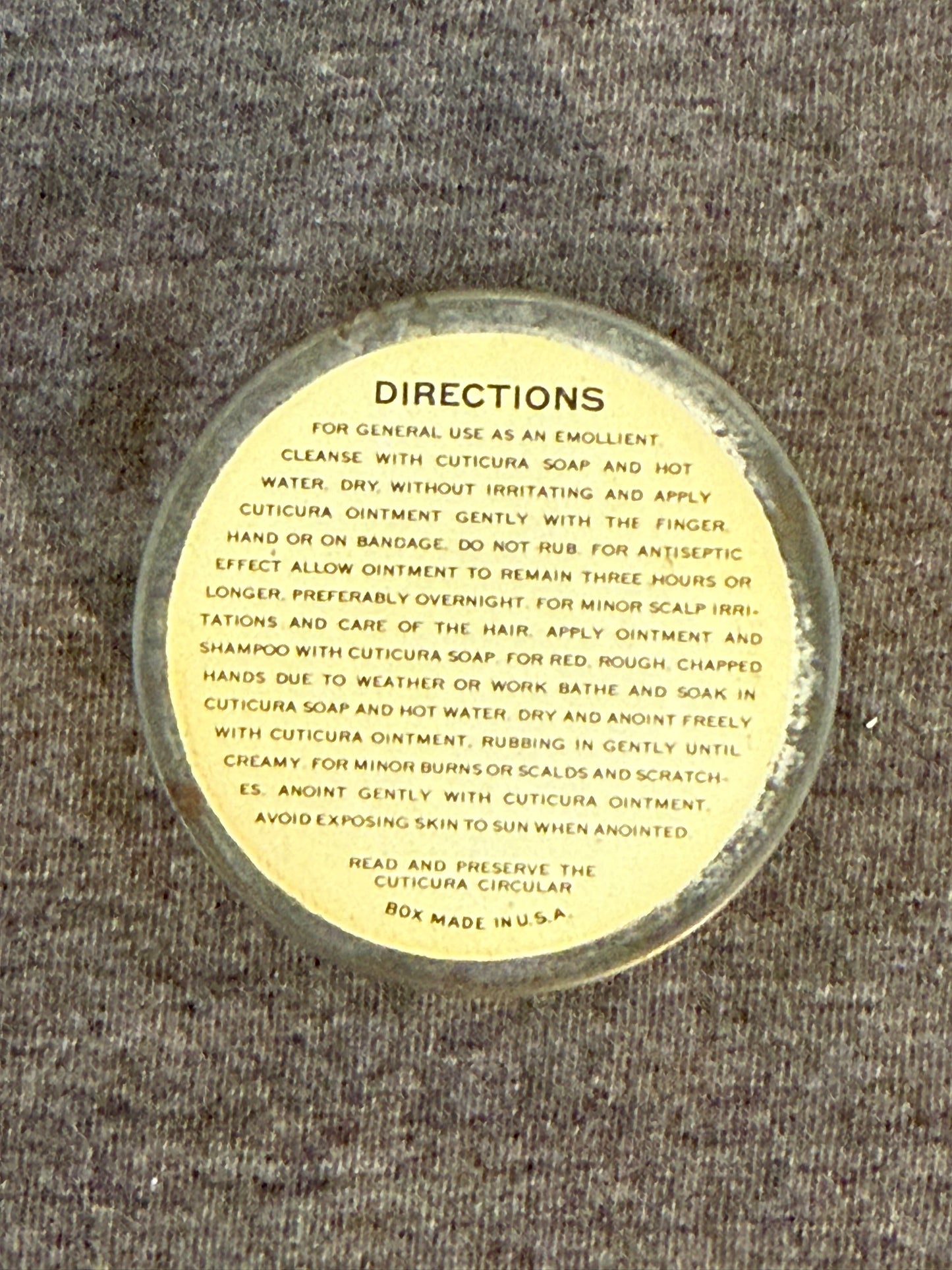 Round label with text on a textured surface