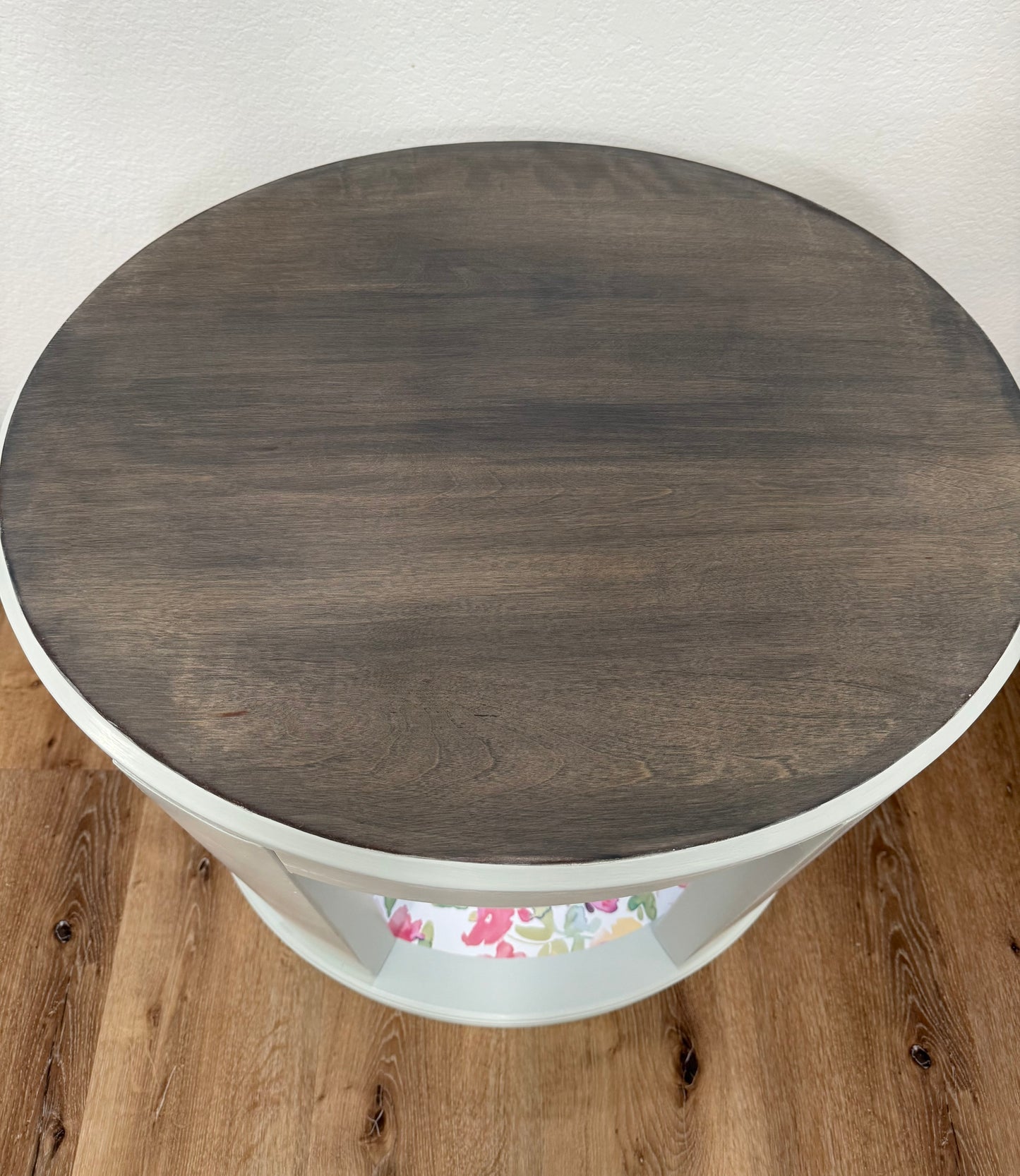 Oval side table on a wooden floor.