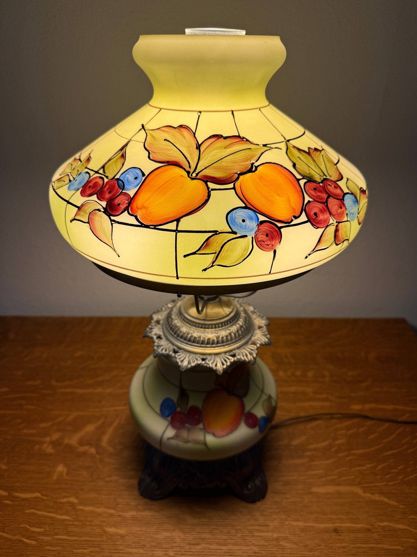 Decorative lamp with fruit design on a wooden surface