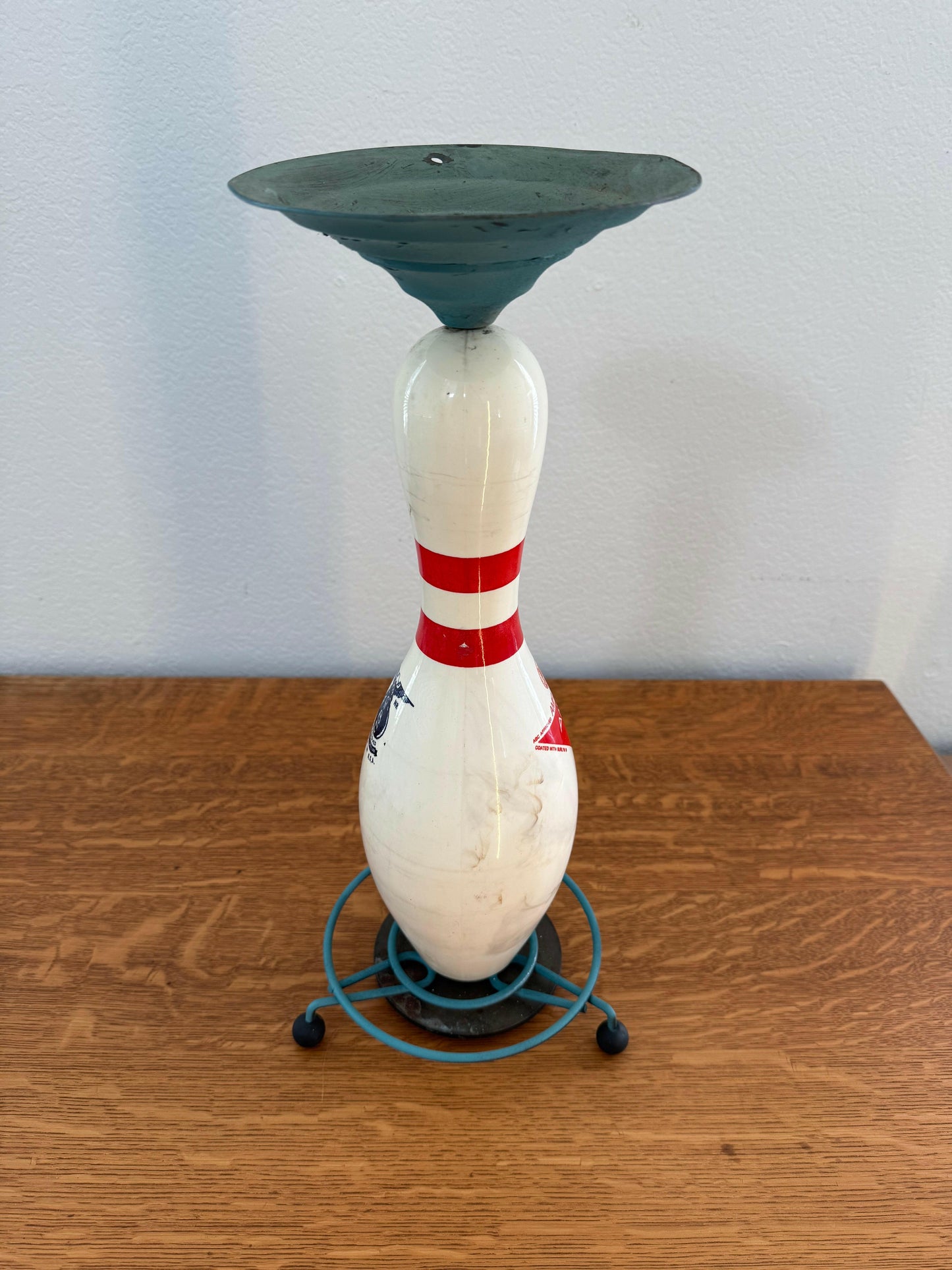 Bowling pin on a wooden surface with a white background