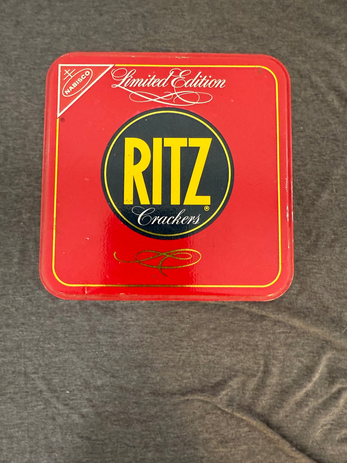 Red Ritz crackers tin on a gray surface