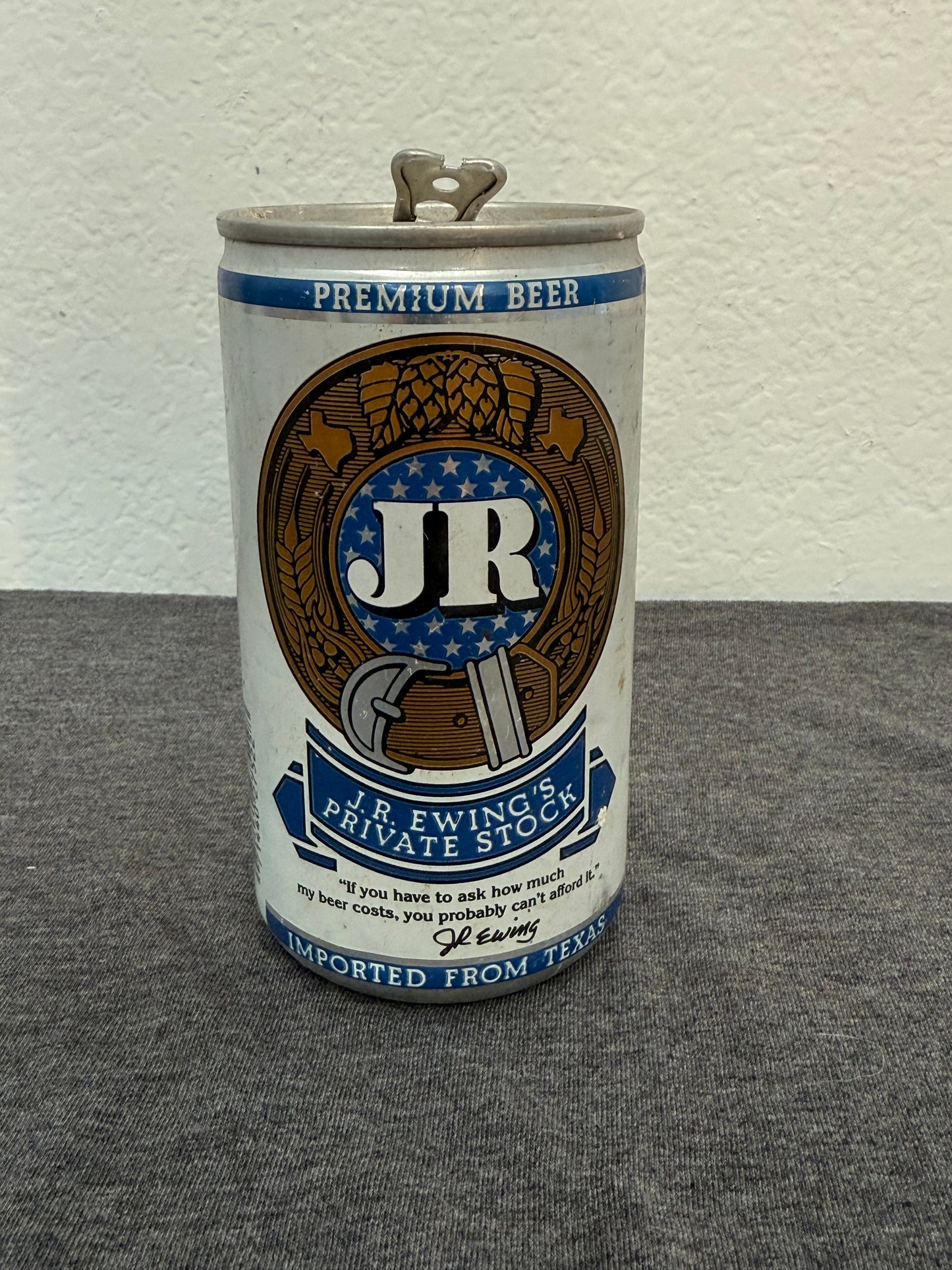 Can of JR Premium Beer on a textured surface