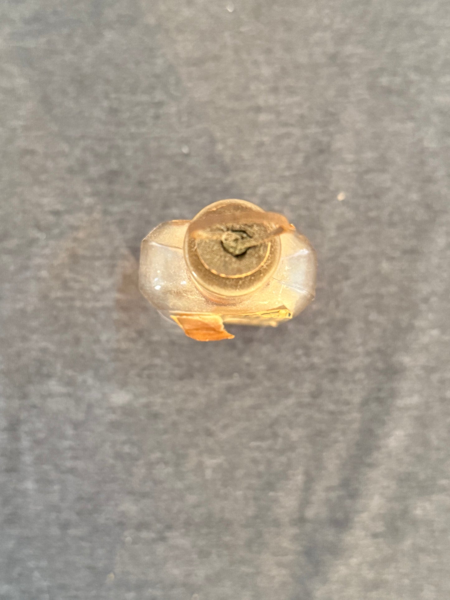 Small gold object on a gray background