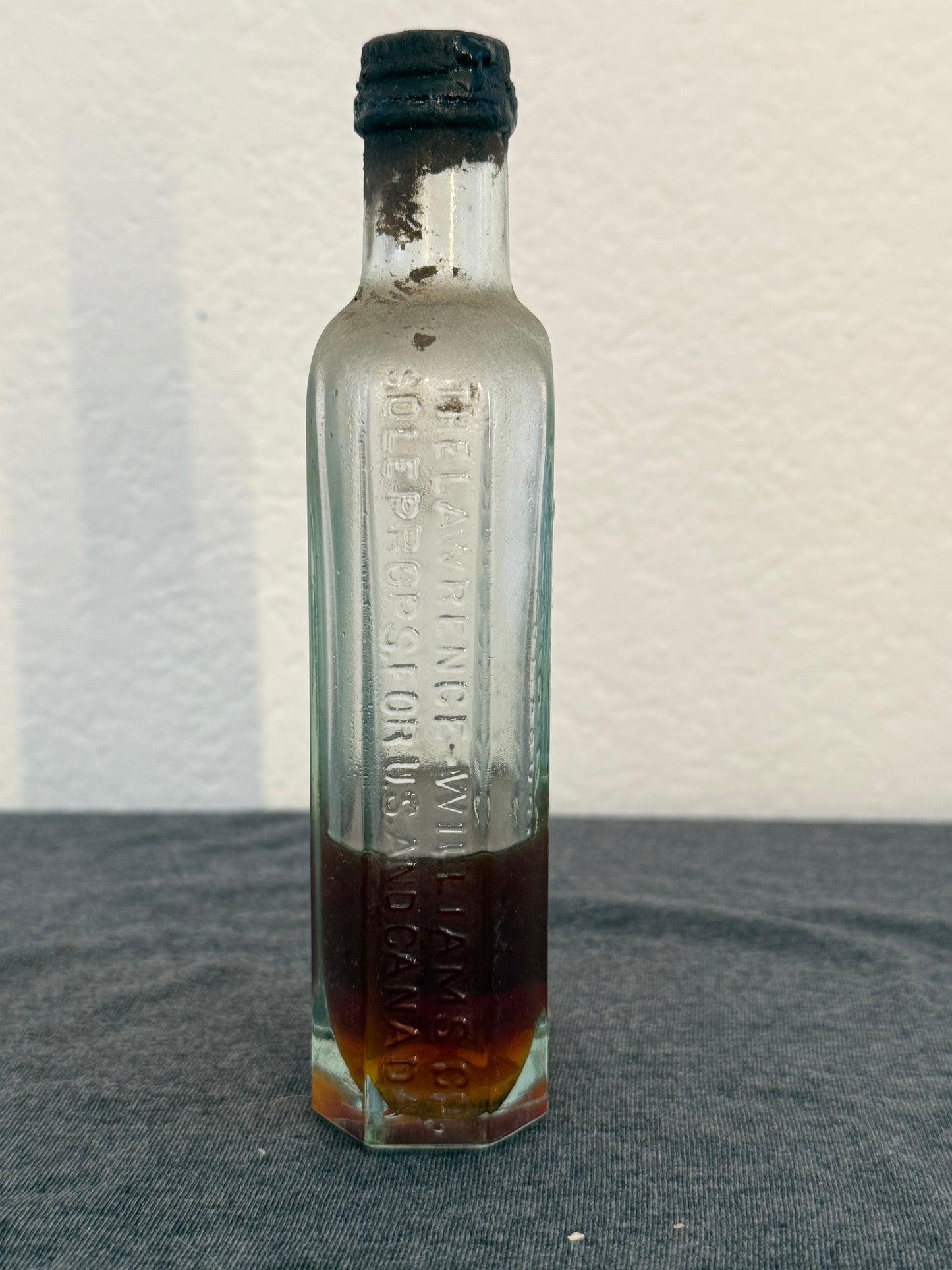 Small glass bottle with a cork stopper on a light background