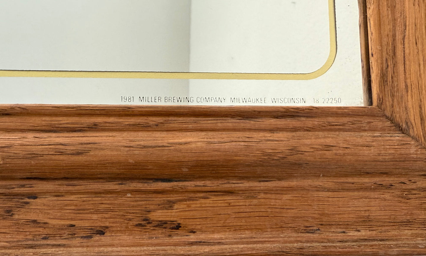 Wooden frame with engraved text on a white background