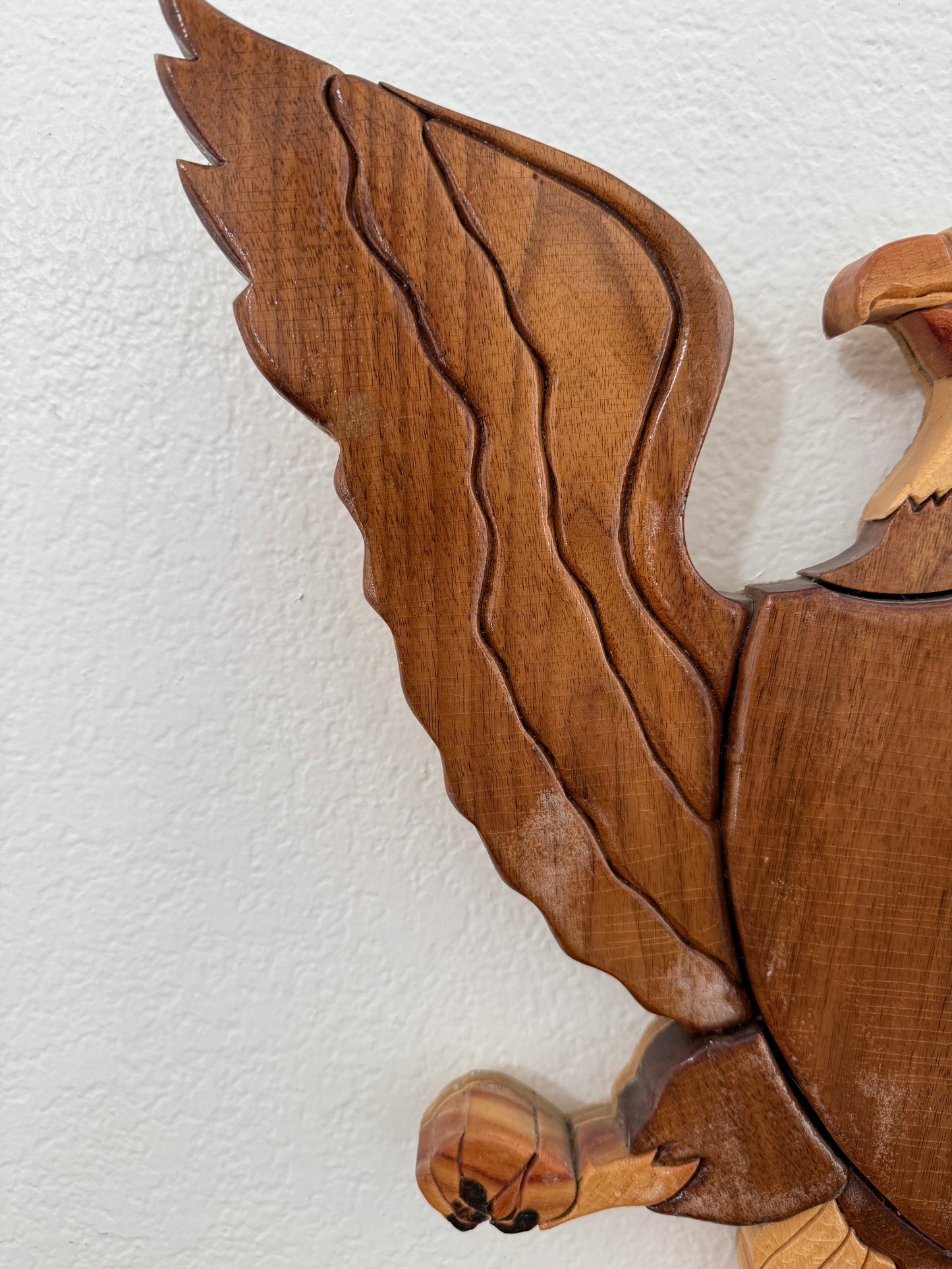 Wooden eagle figurine on a white background