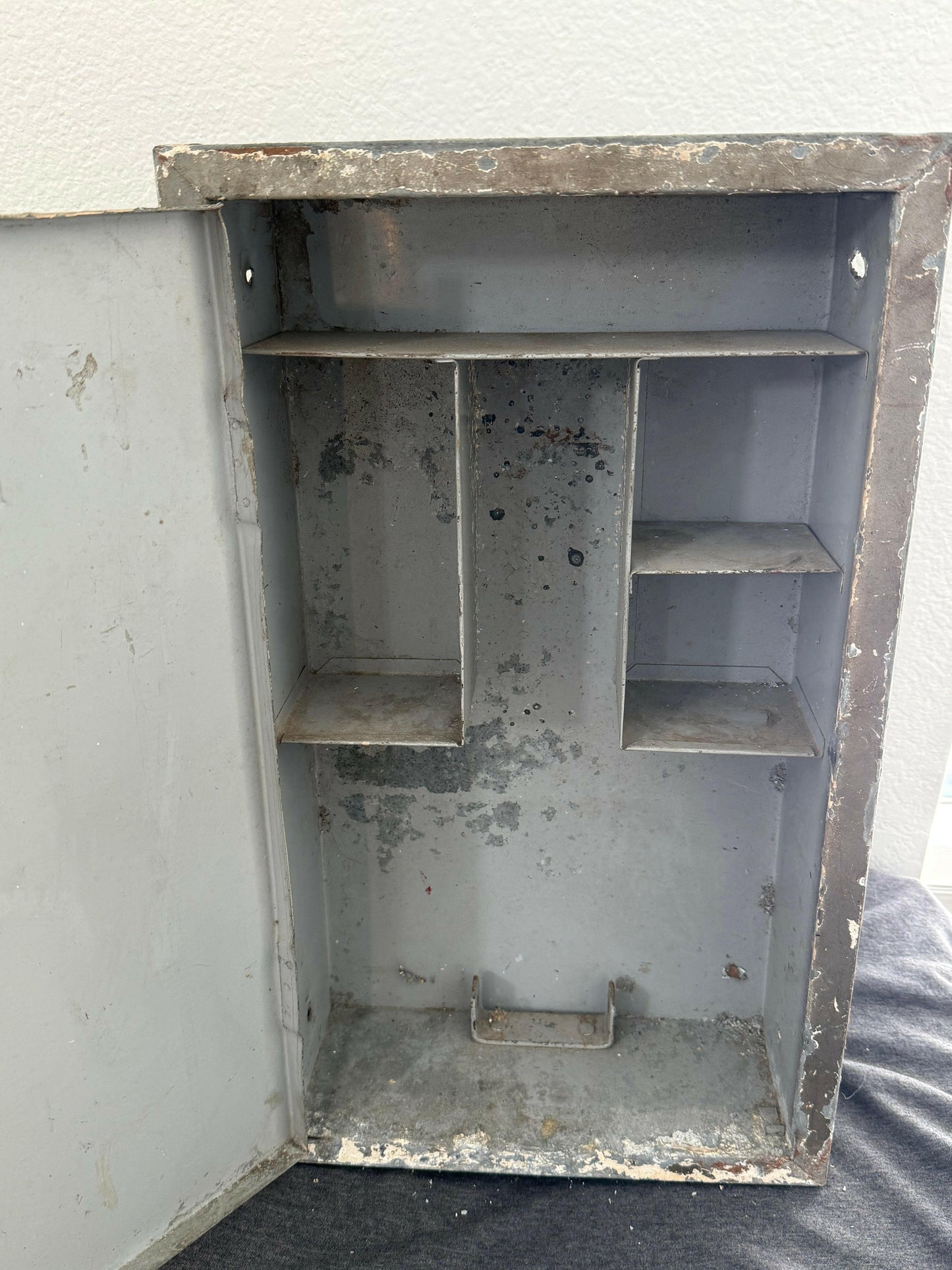Metallic box with compartments on a plain background