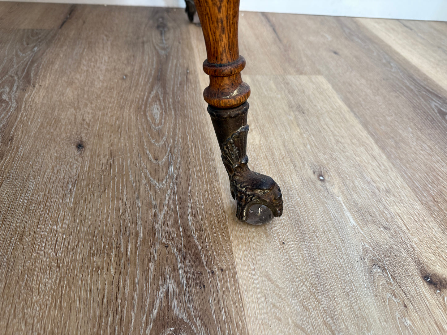Wooden leg with decorative carvings on a wooden floor