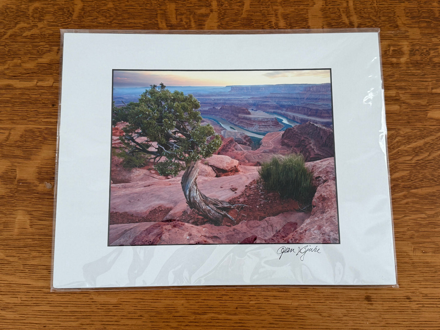 Scenic landscape print on a wooden surface