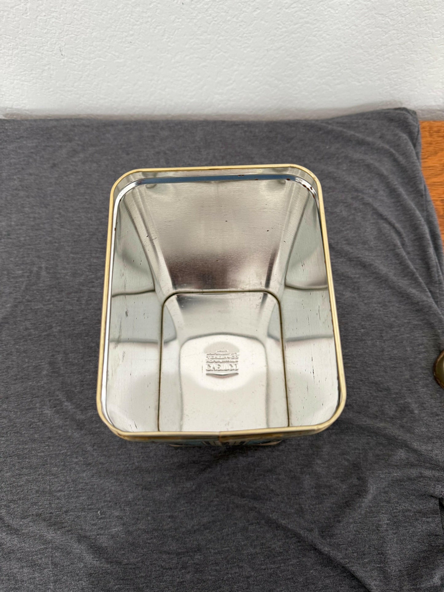 Metallic rectangular object on a gray surface
