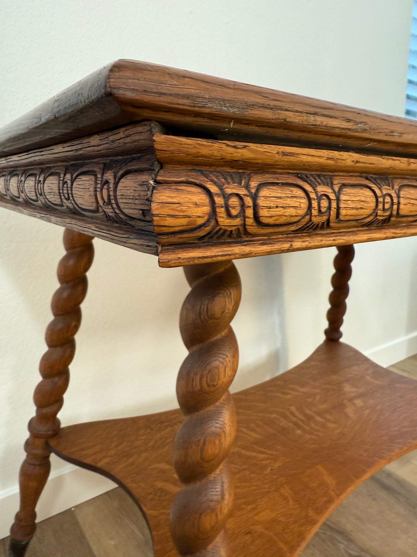 Close-up of a wooden table with intricate carvings on a white background