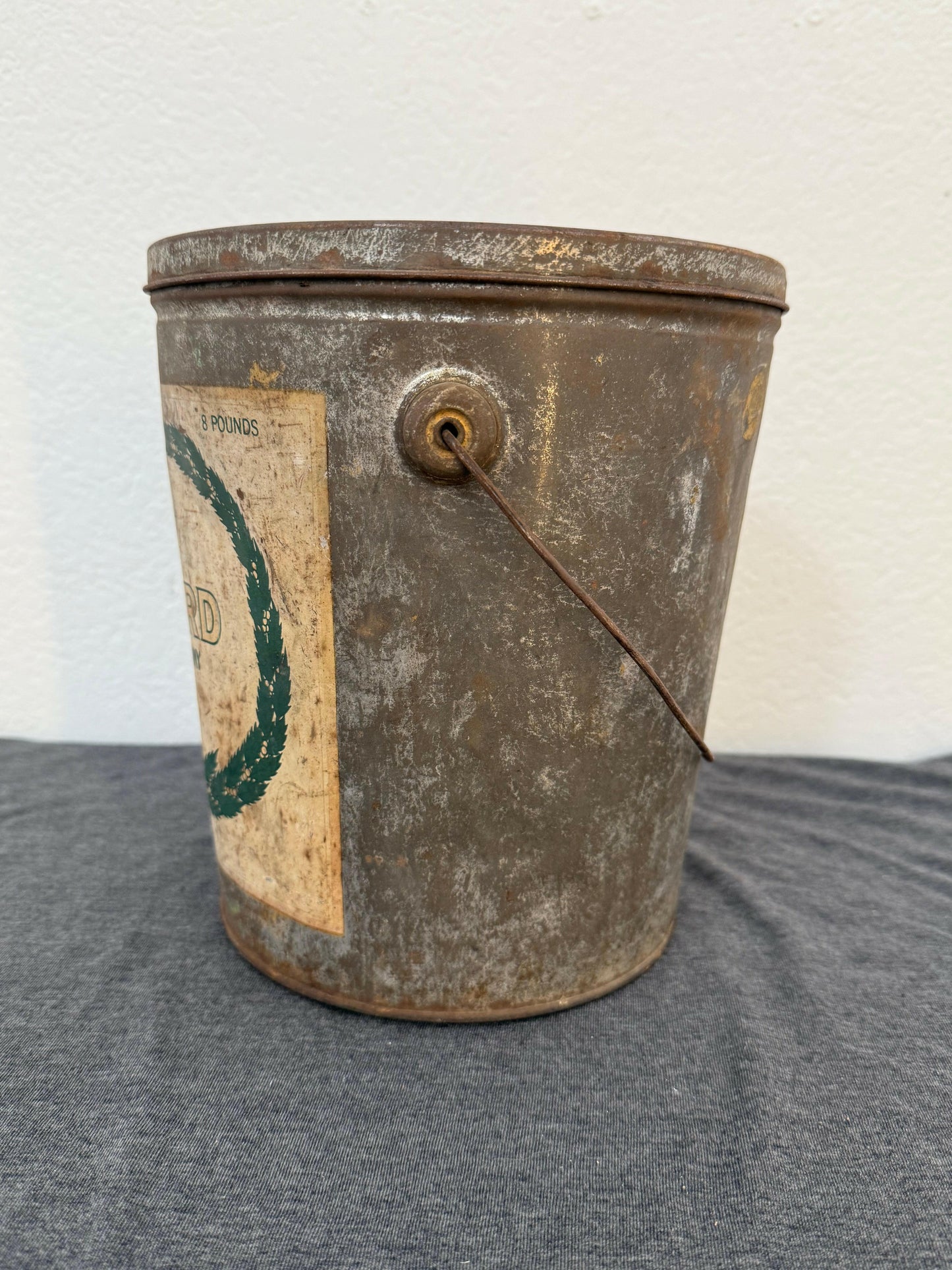 Vintage metal can with a label on a gray background