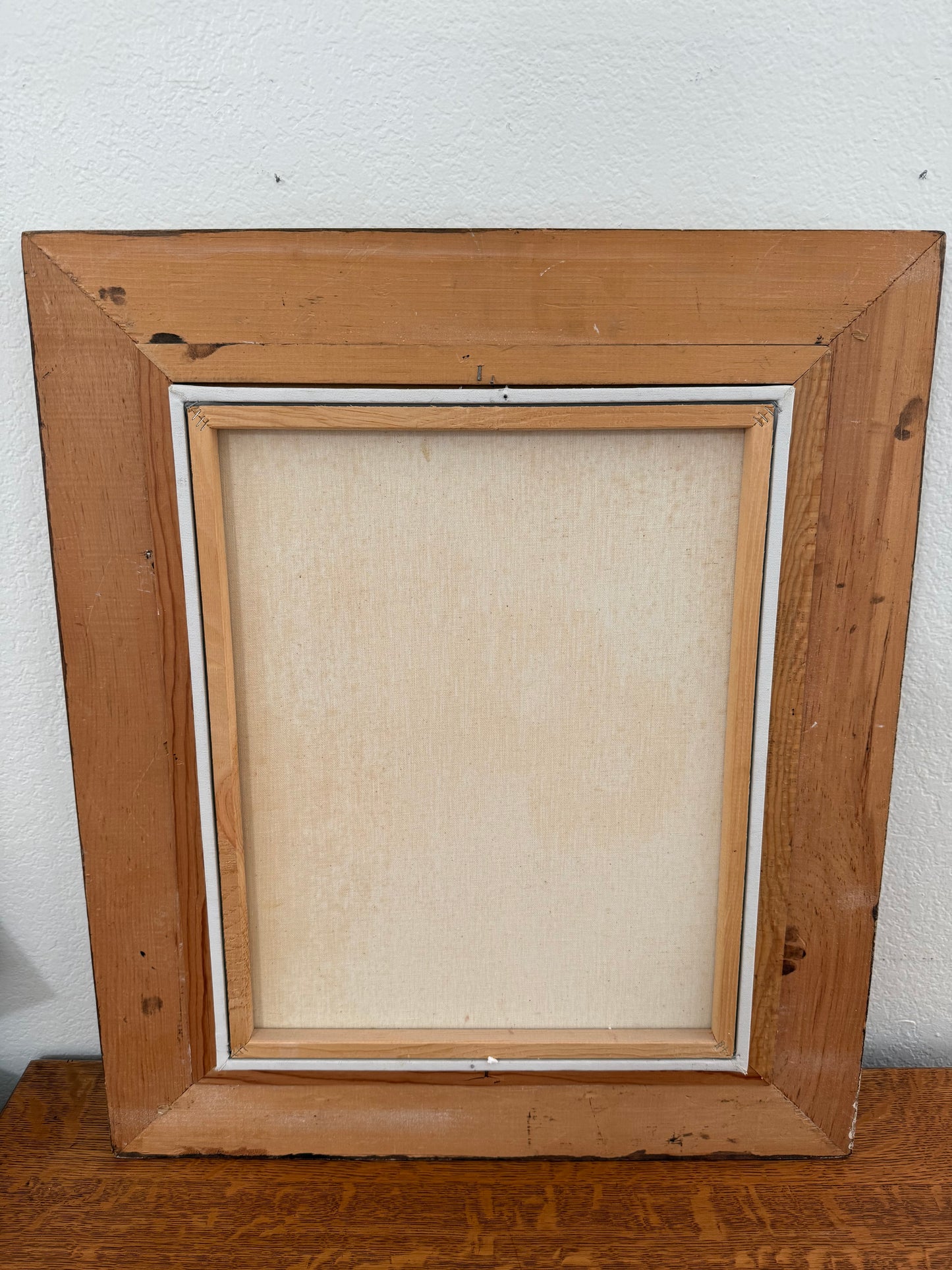 back of Wooden picture frame on a white wall