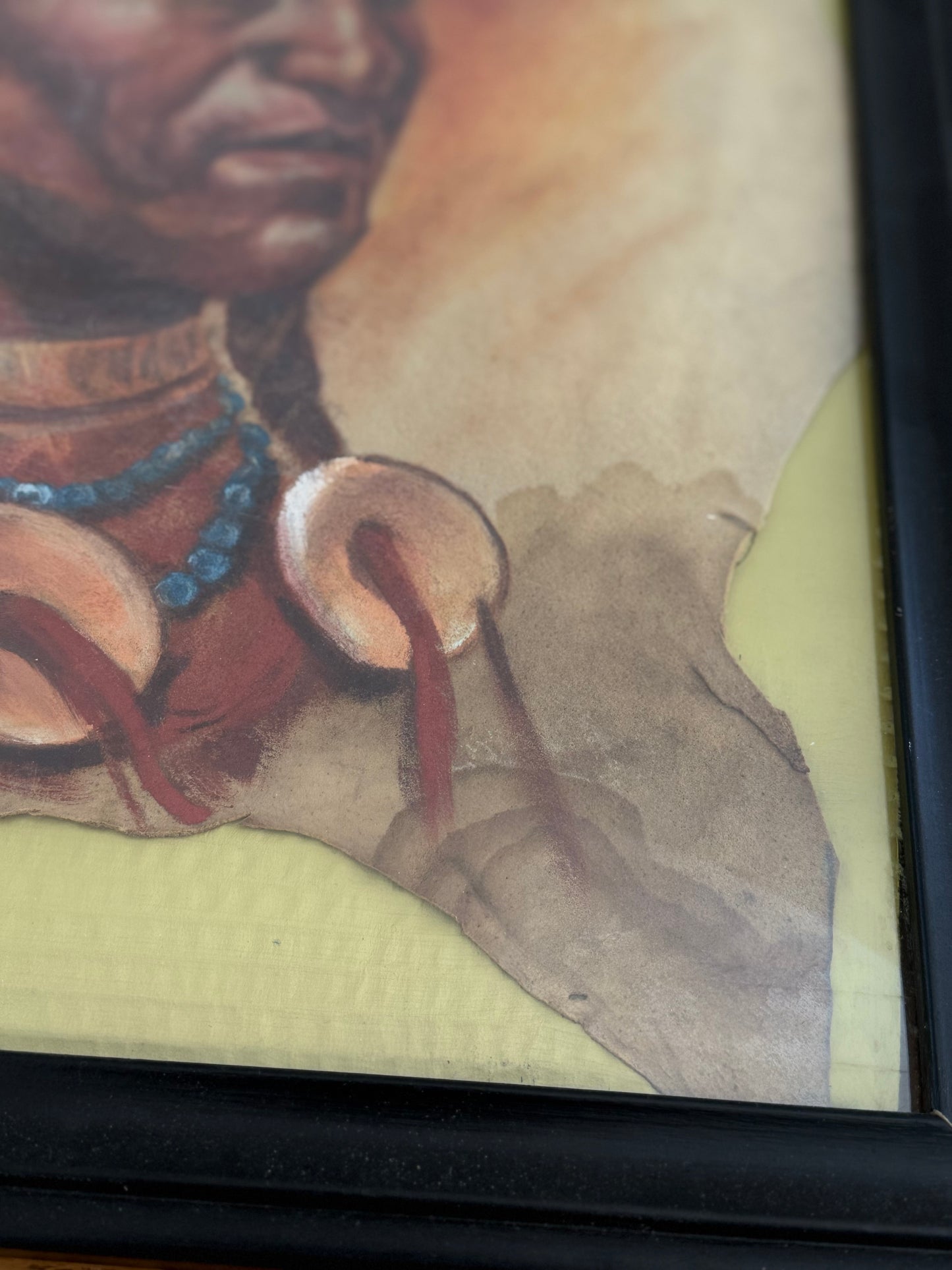 Close-up of a person wearing large earrings with a blurred background