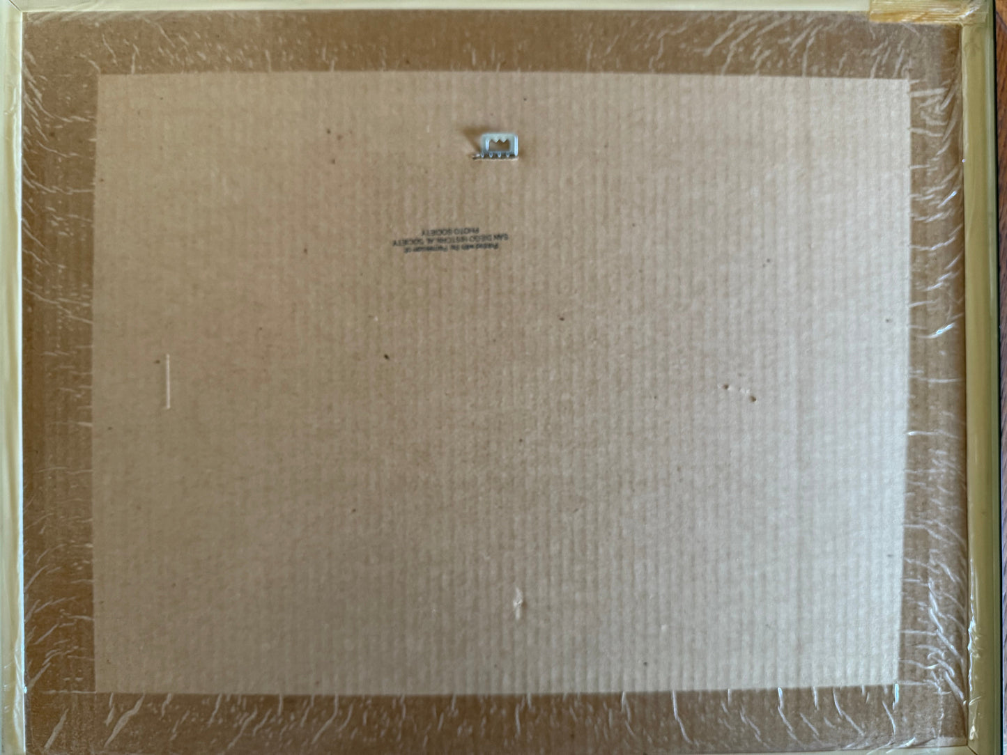 Back of a framed picture with bubble wrap and cardboard
