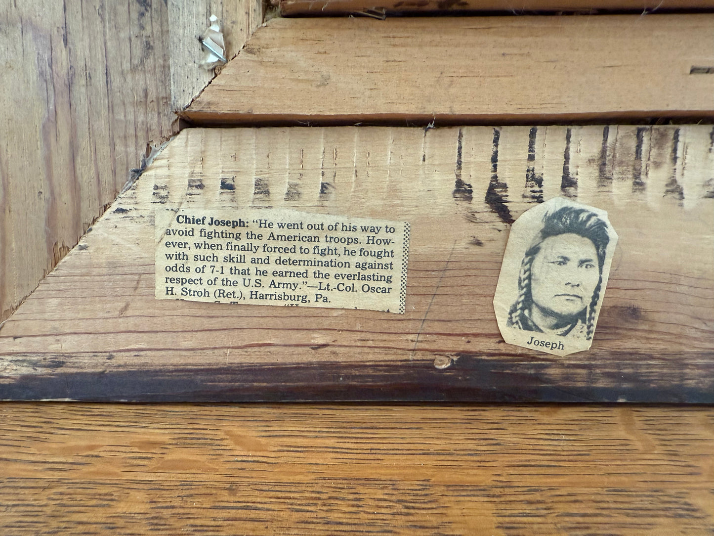 Wooden surface with a cutout of Chief Joseph's face and text on it.