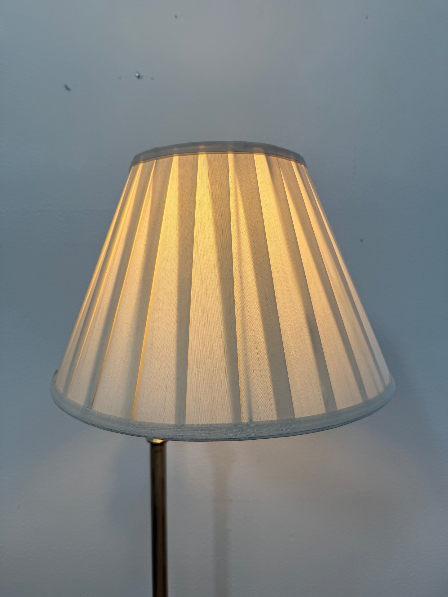 Lampshade with pleated design on a plain background