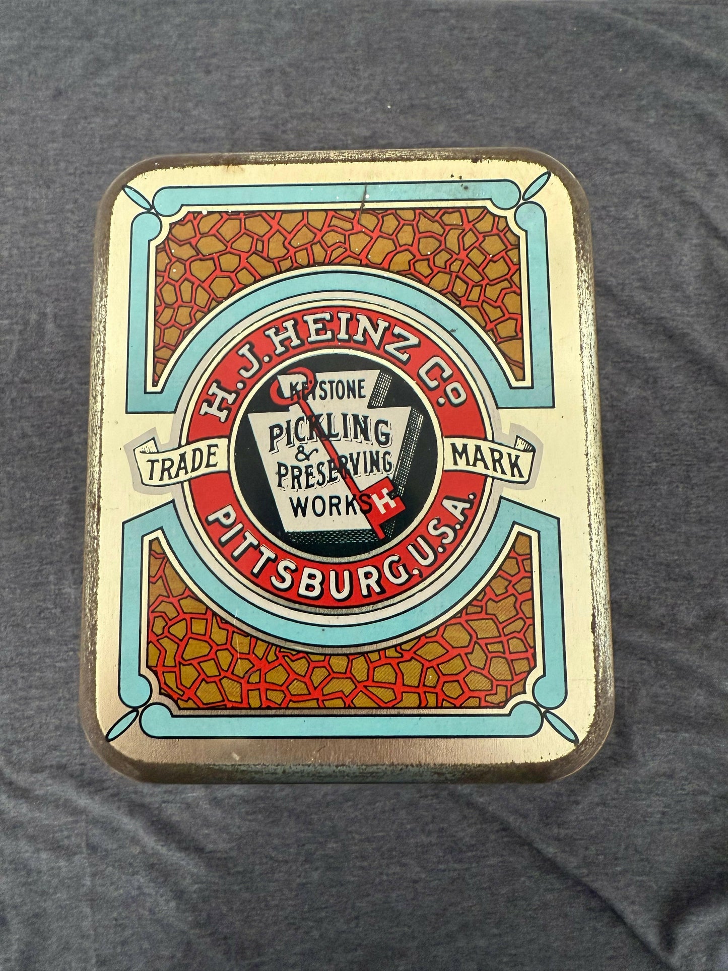 Vintage-style product packaging with decorative border on a gray background