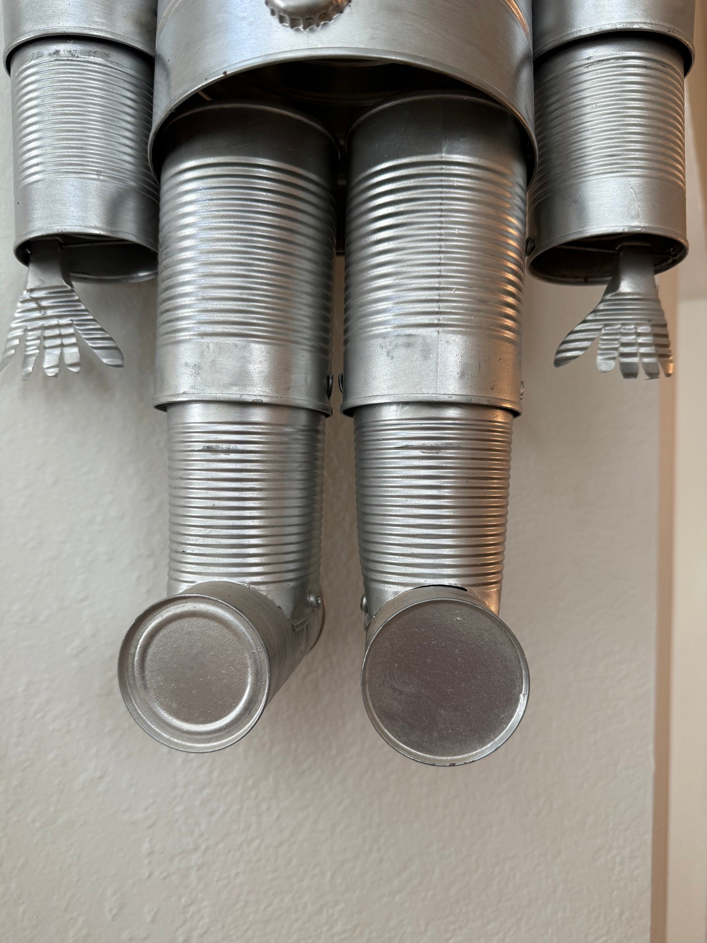 Metallic cylindrical objects with textured ends on a light gray surface
