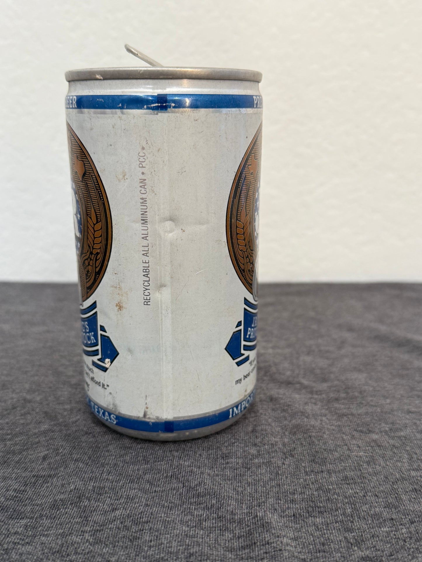Aluminum can on a white and gray surface