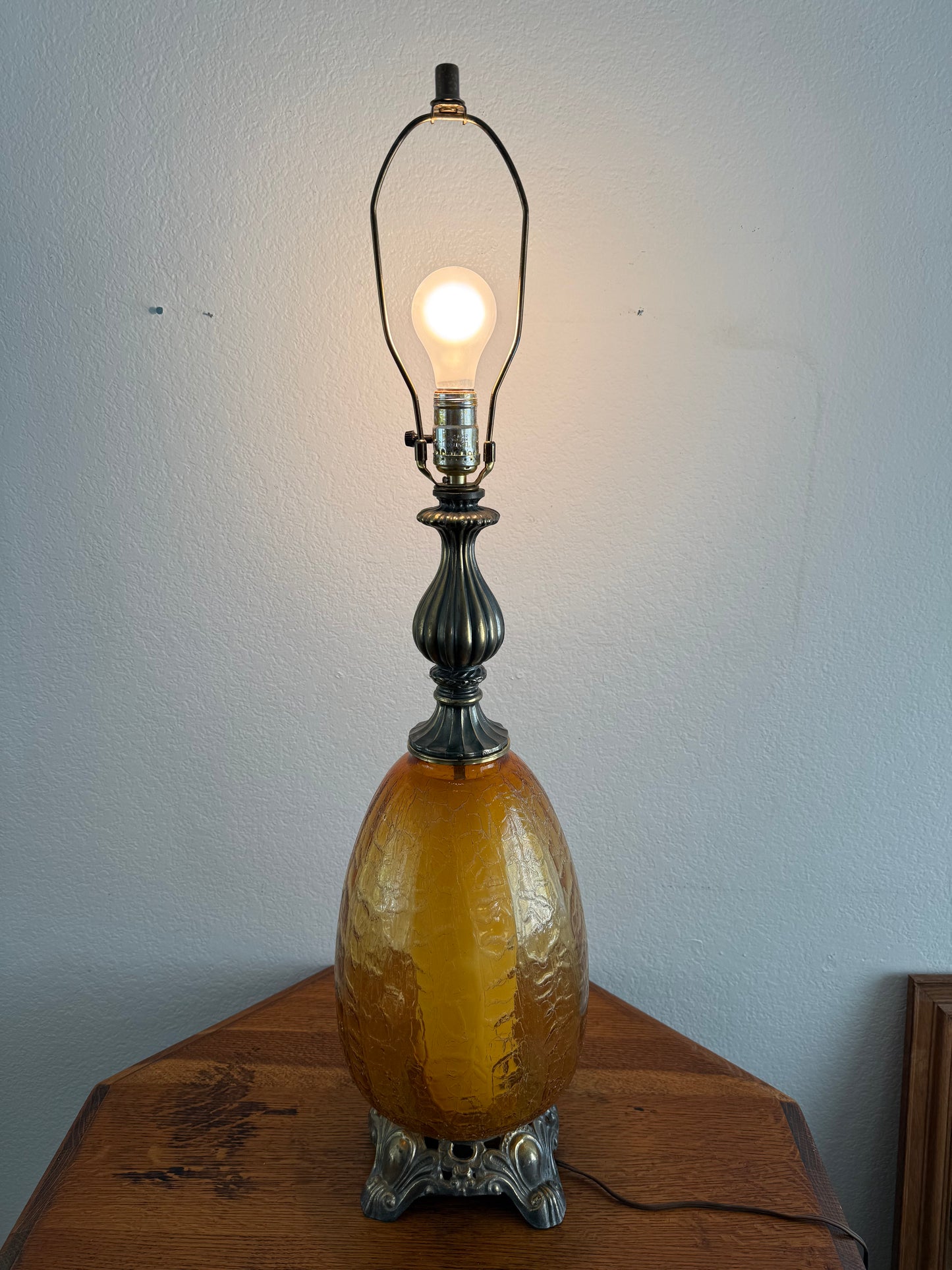 Vintage-style lamp with a glowing light bulb on a plain background