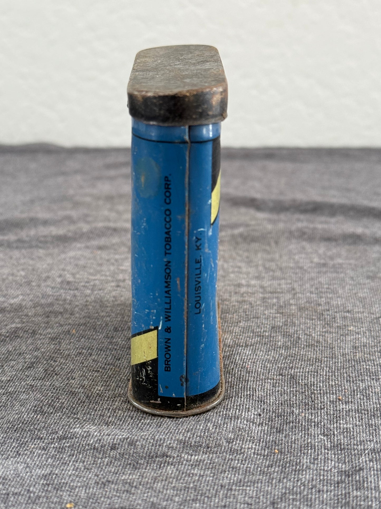 Blue cylindrical object with text on a textured surface