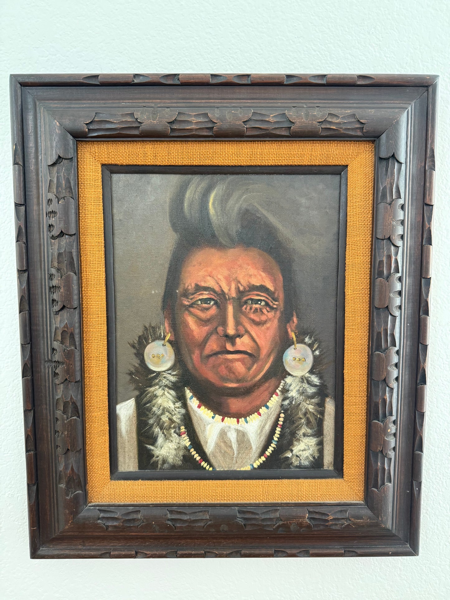 Framed portrait of a Native American Chief with decorative elements on a light gray background
