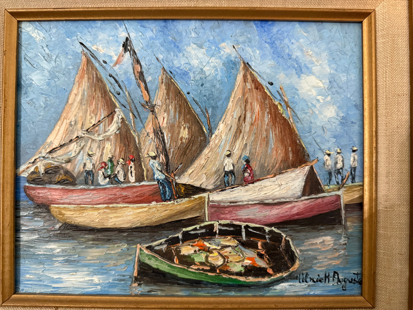 Painting of sailboats with people on a blue sky background, framed in gold.