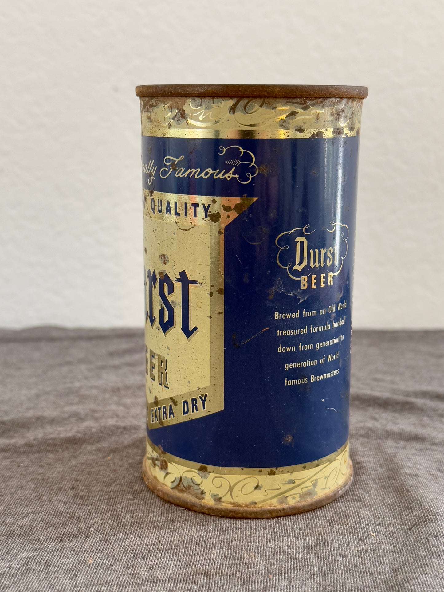 Vintage-style beer can with blue and gold design on a plain background