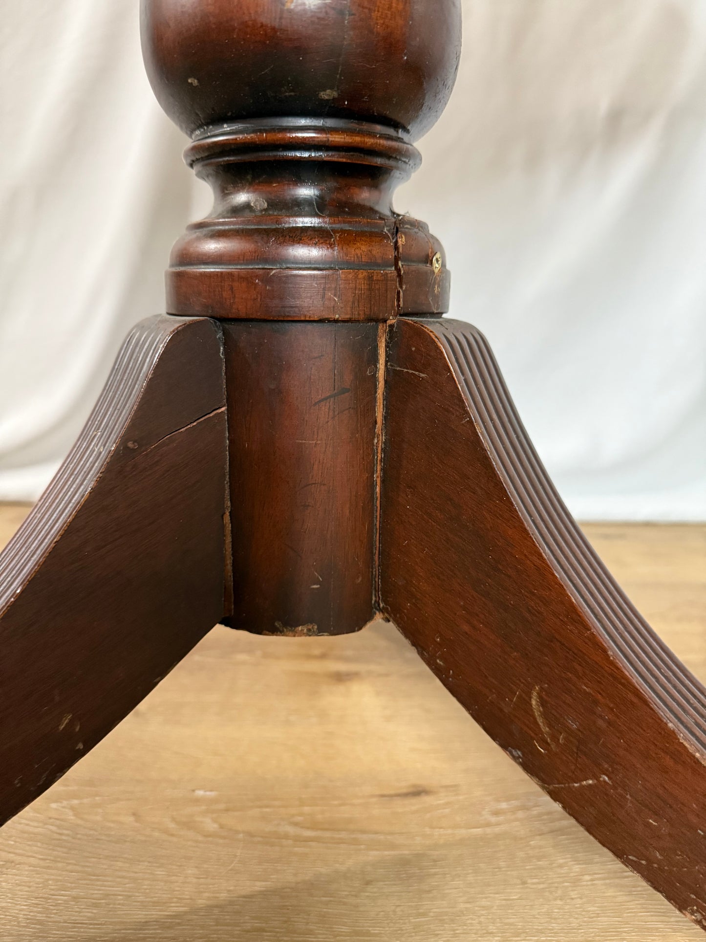 Close-up of a wooden table leg with a blurred background