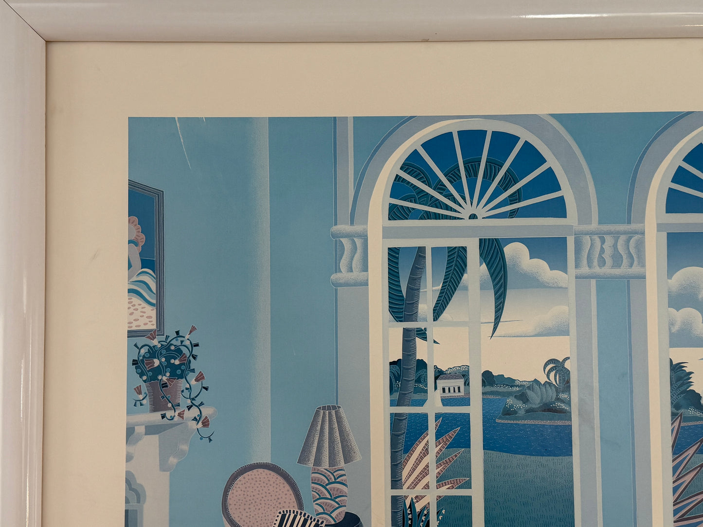 Decorative mural with a window view, lamp, and plants in a frame.