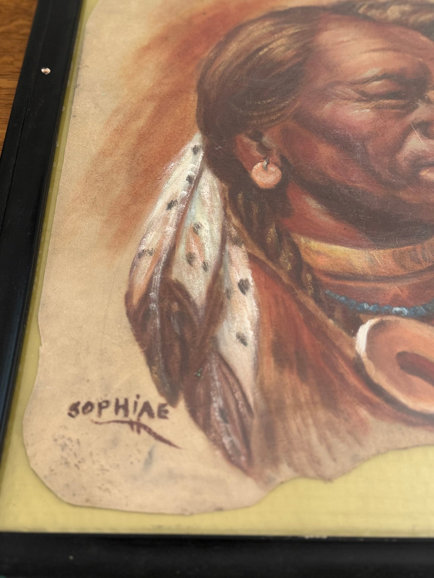 Artistic depiction of a Native American figure with intricate details on a textured background