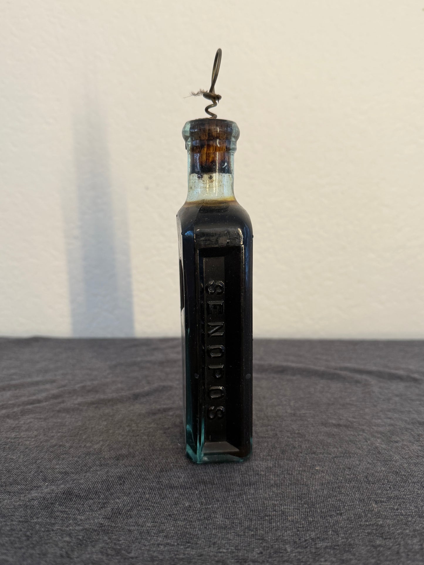 Vintage bottle with cork on a light beige and dark gray background