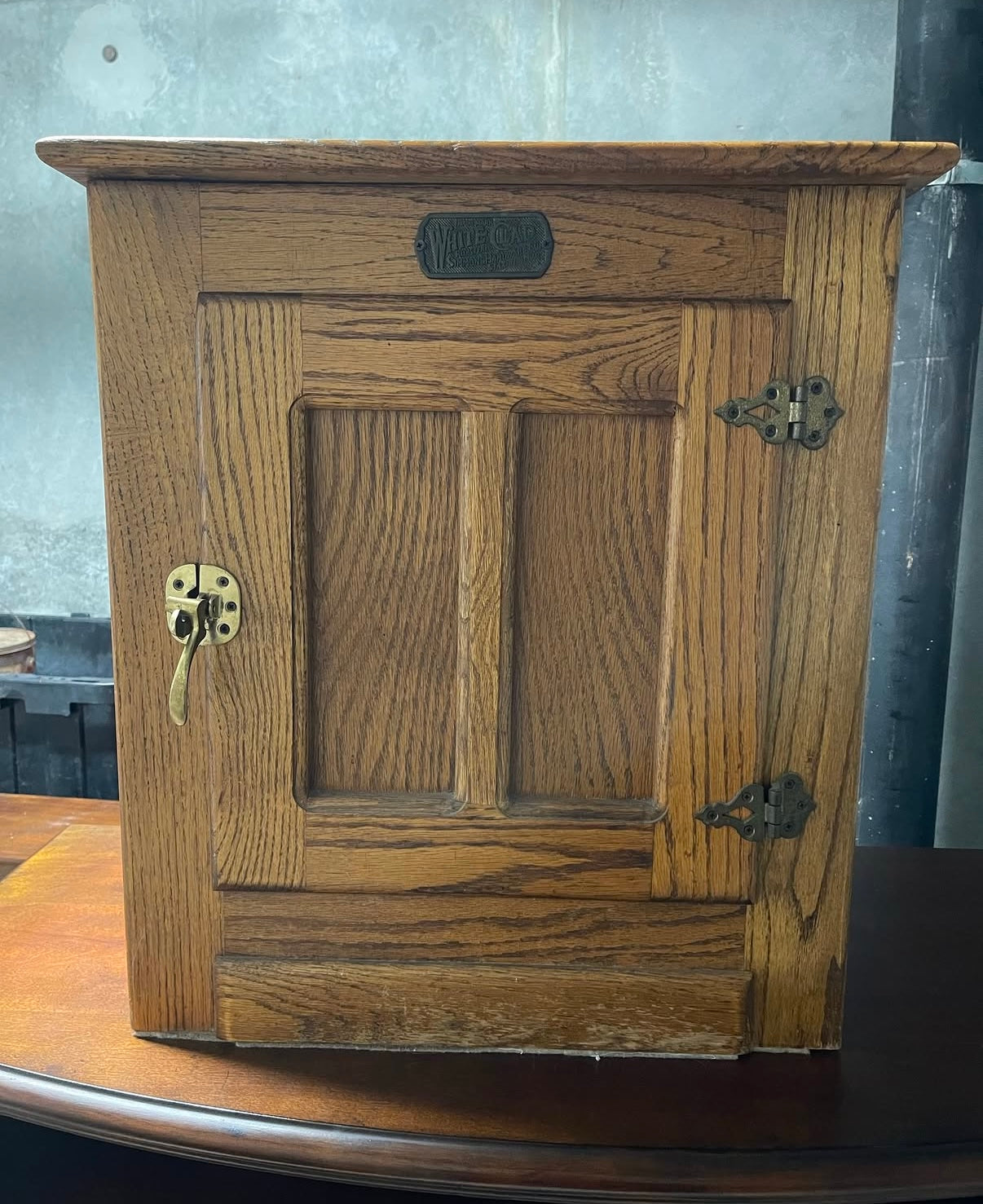 Wooden White Clad cabinet with a lock on a wooden surface
