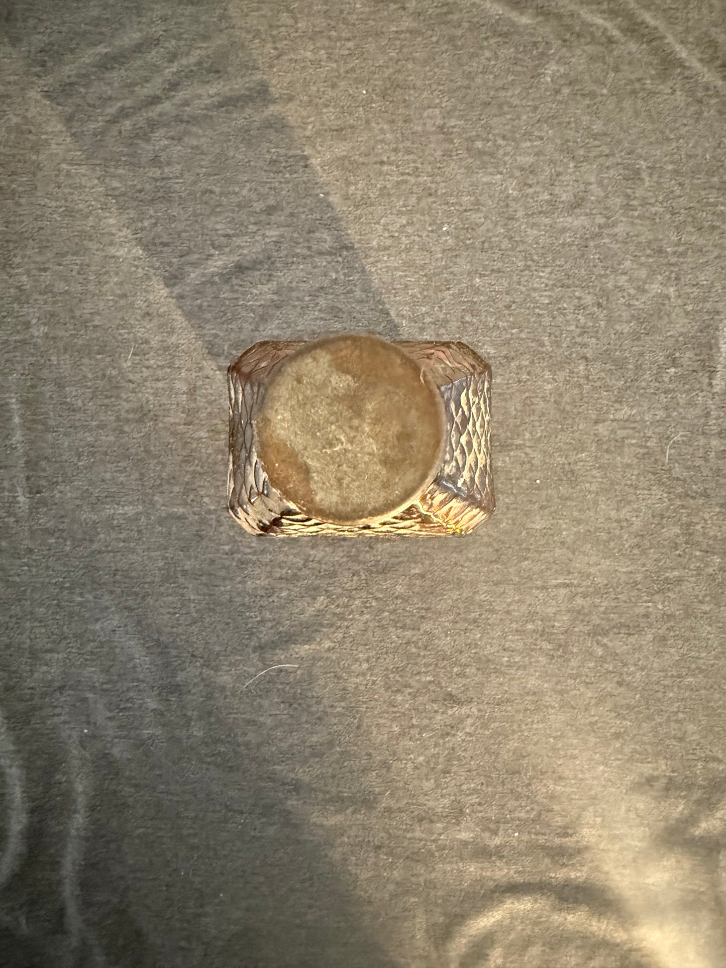 Gold ring on a textured gray surface
