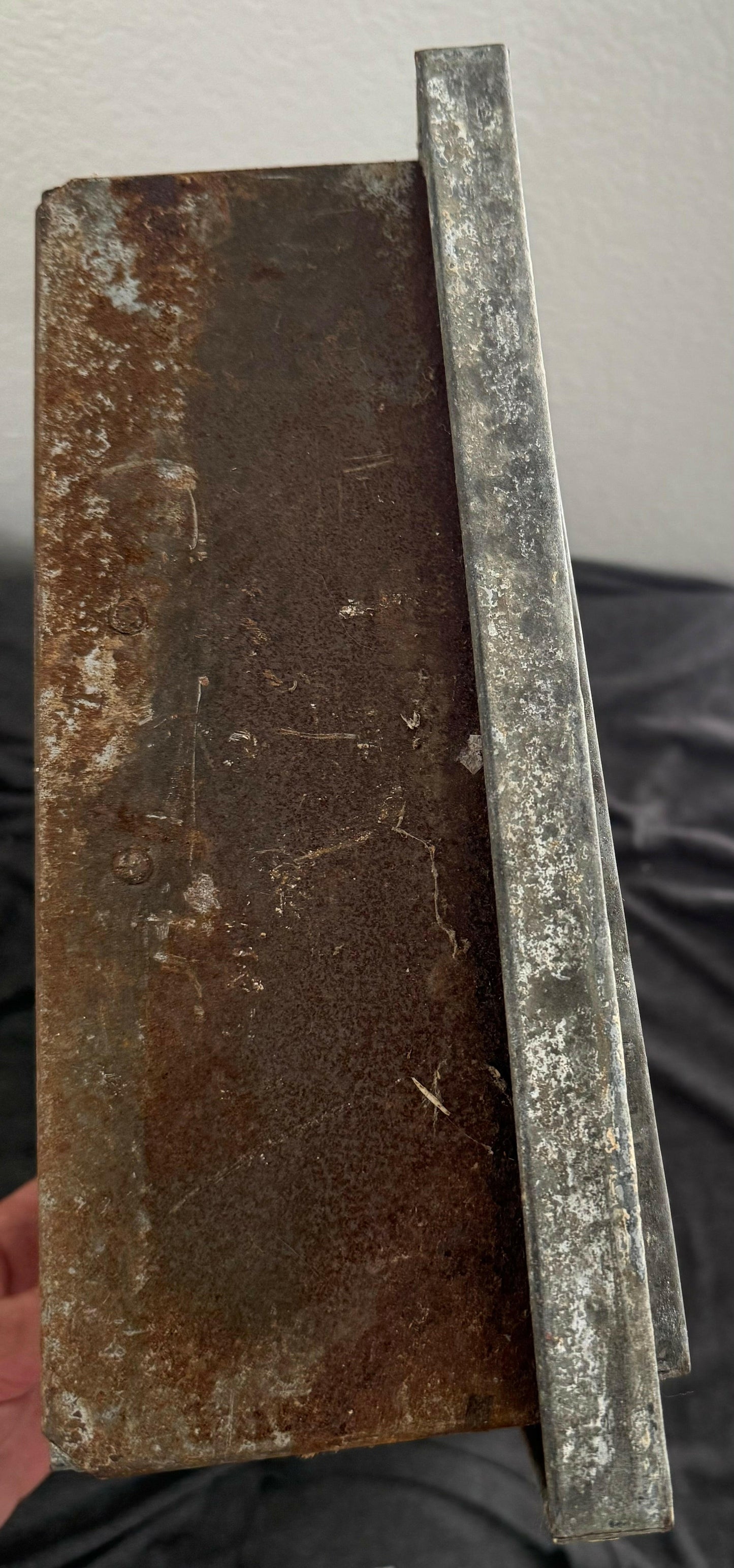 Rusty metal block with a straight edge on a white background