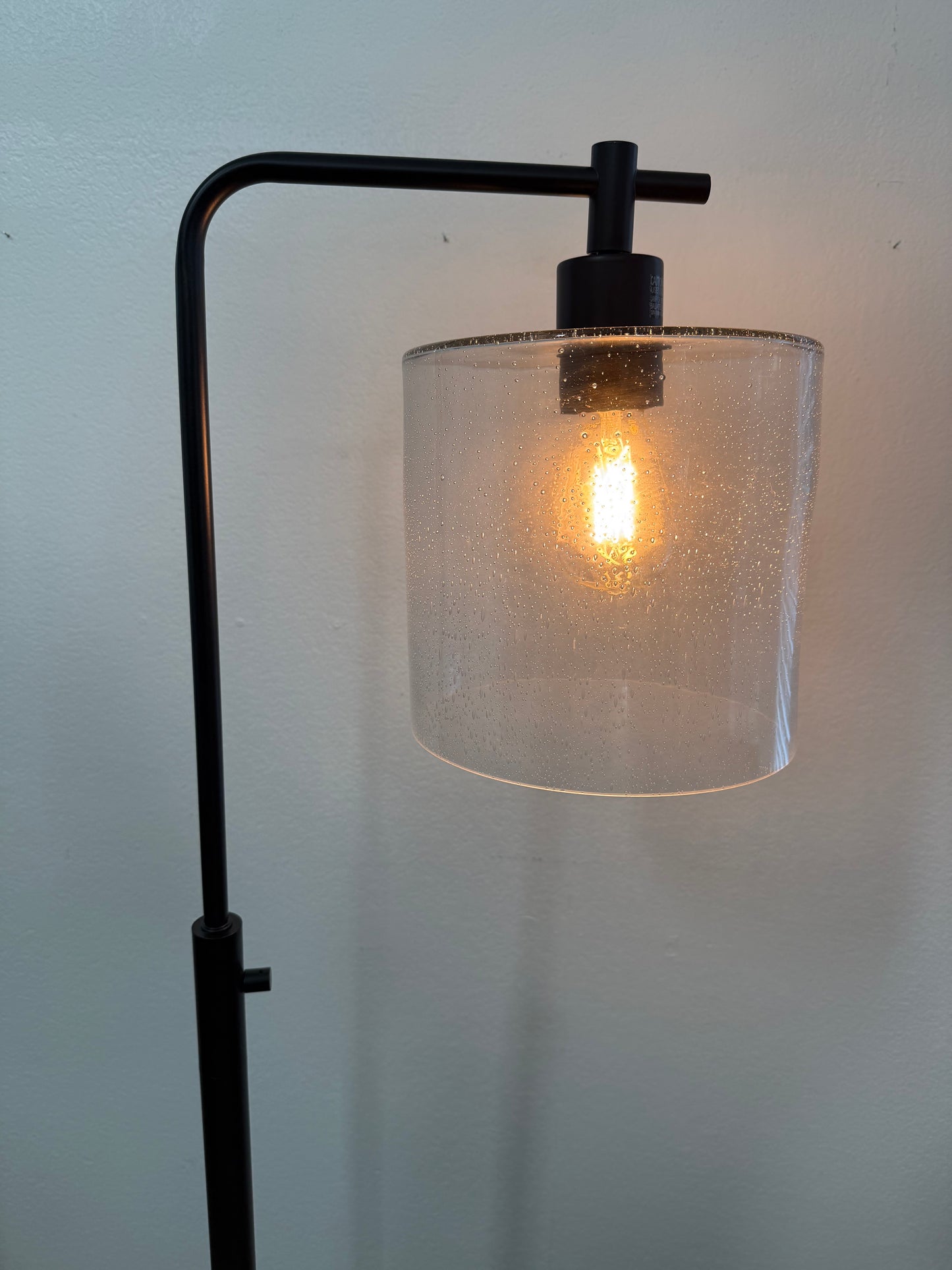 lamp with a glass shade on a plain wall