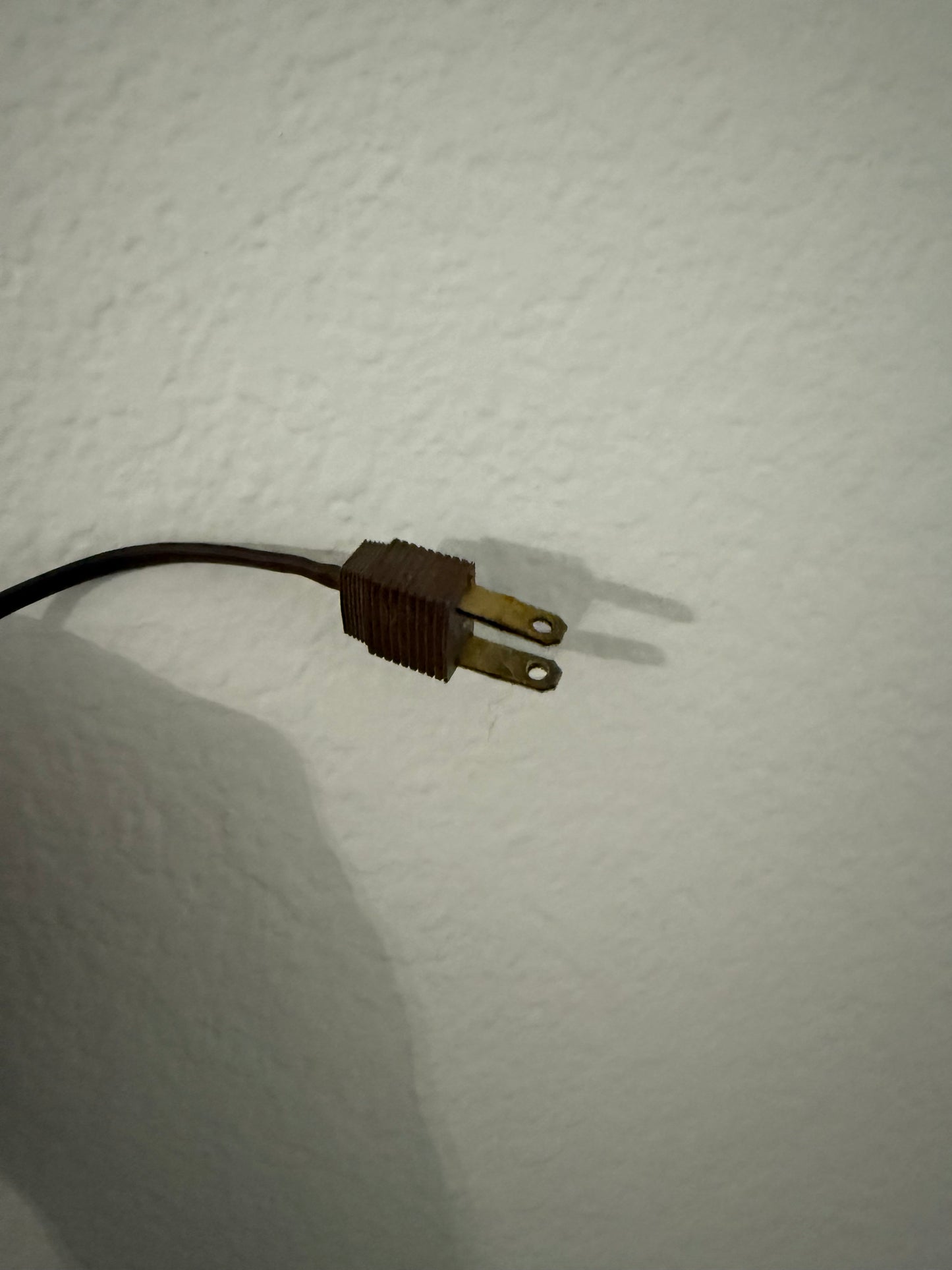 Electrical plug on a white wall