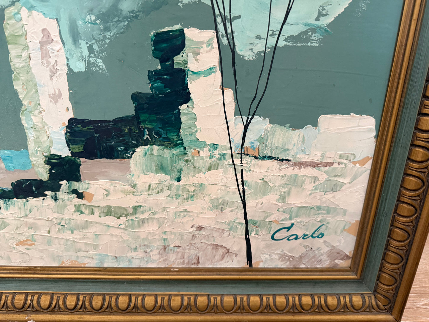 Abstract painting with a gold frame and 'Carlo' signature.