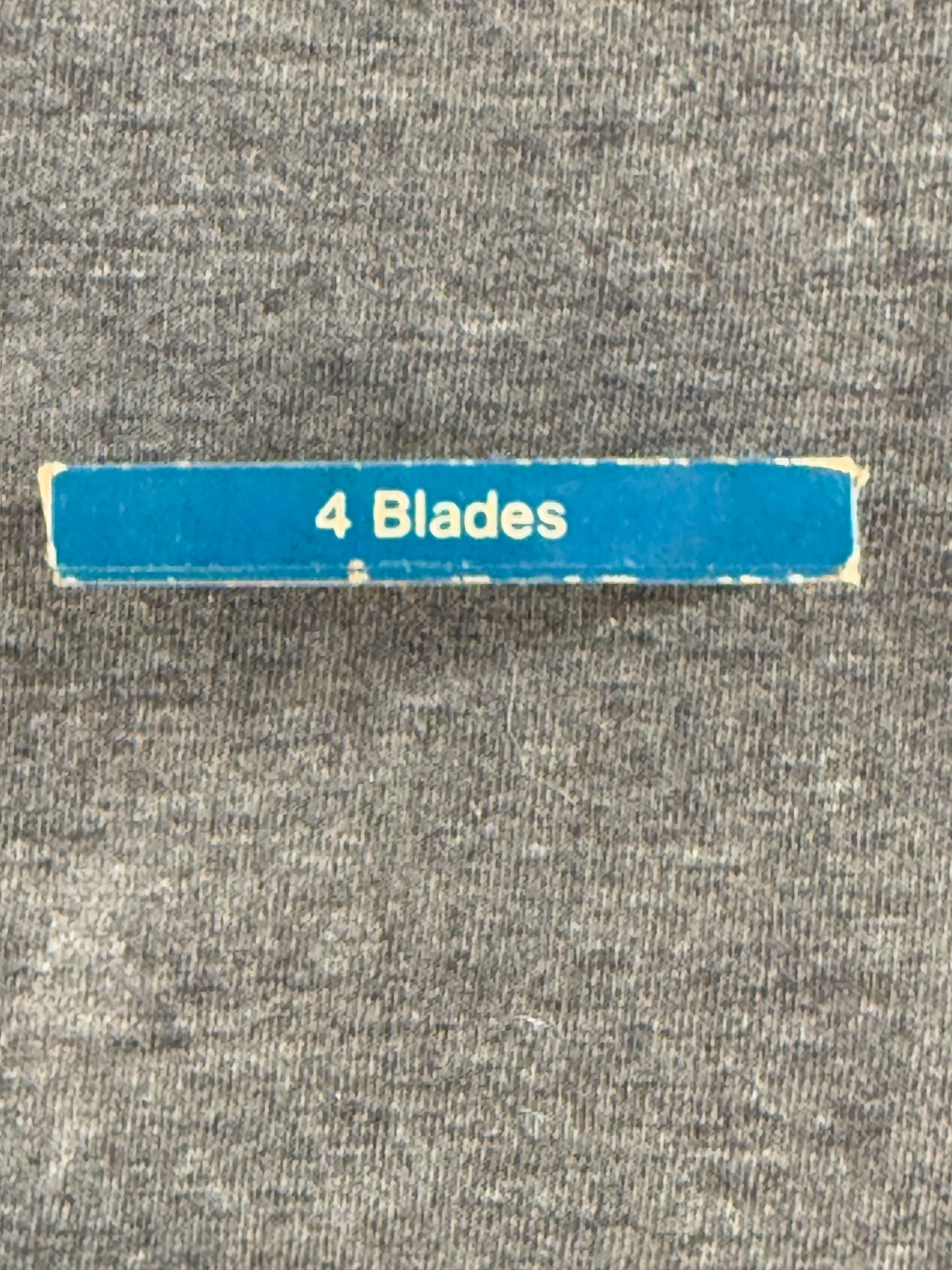 Blue strip with '4 Blades' text on a gray textured background