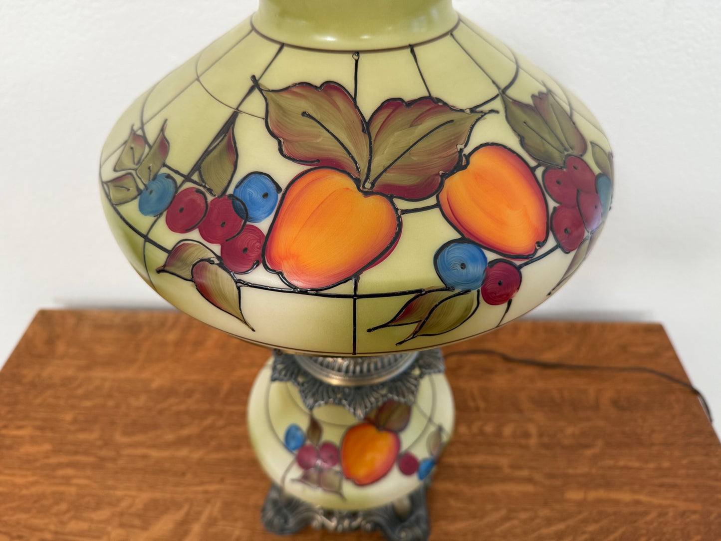 Decorative lamp with fruit design on a wooden surface