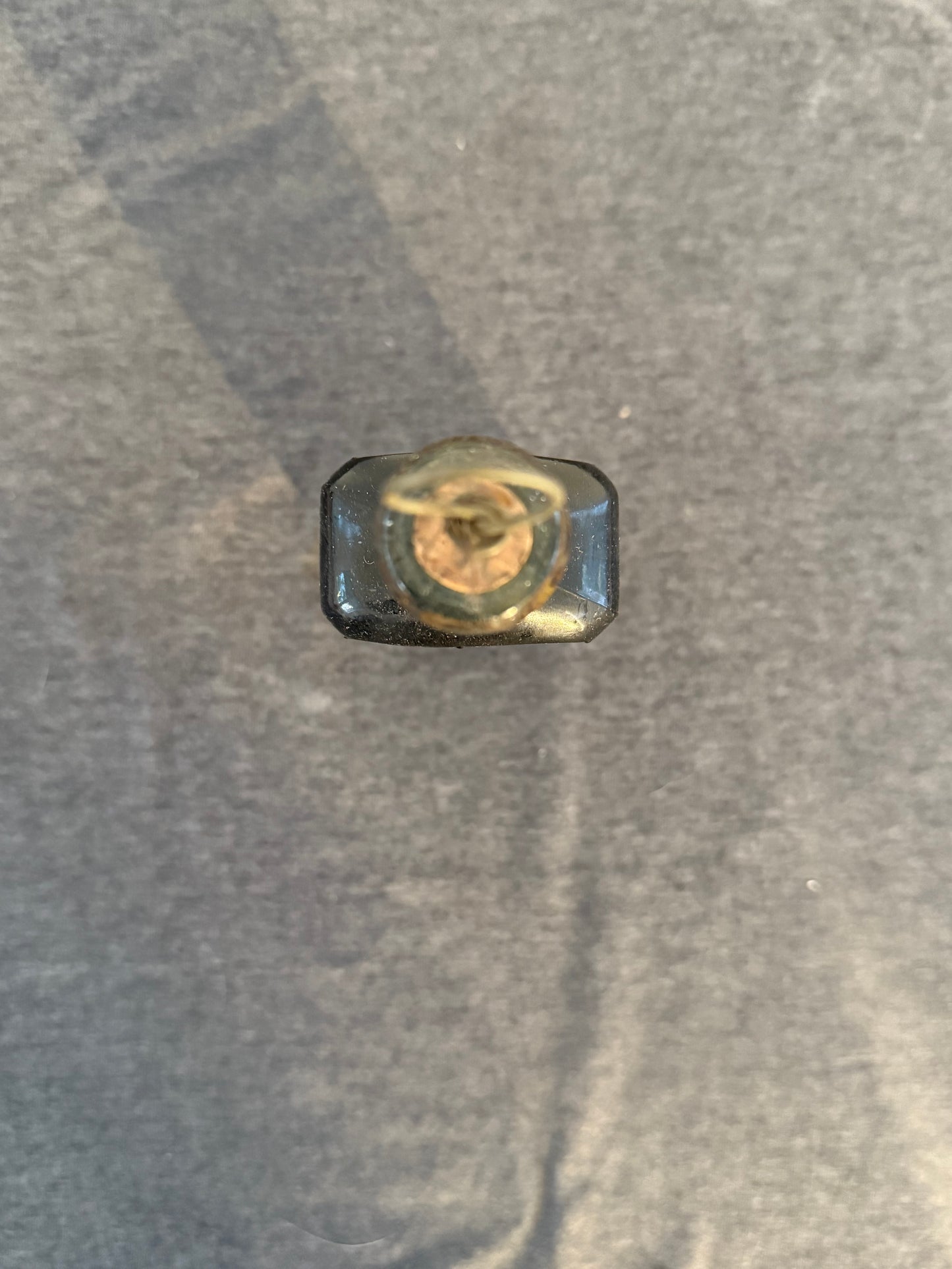 Metallic lid on a textured gray surface